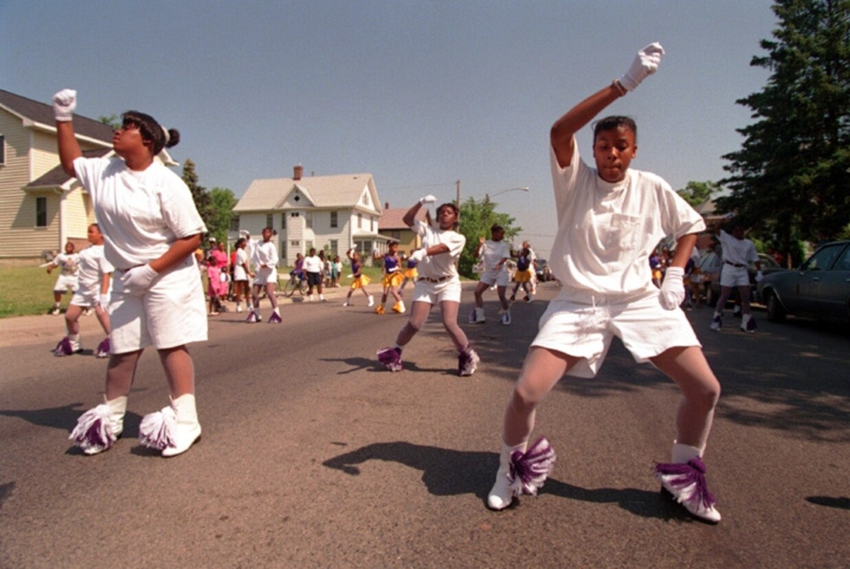 THE OAK PARK DRILL TEAM MAKES THEIR WAY THROUGH NORTH MINNEAPOLIS IN PARADE FORMATION AS PART OF JUNETEENTH CELEBRATIONS.