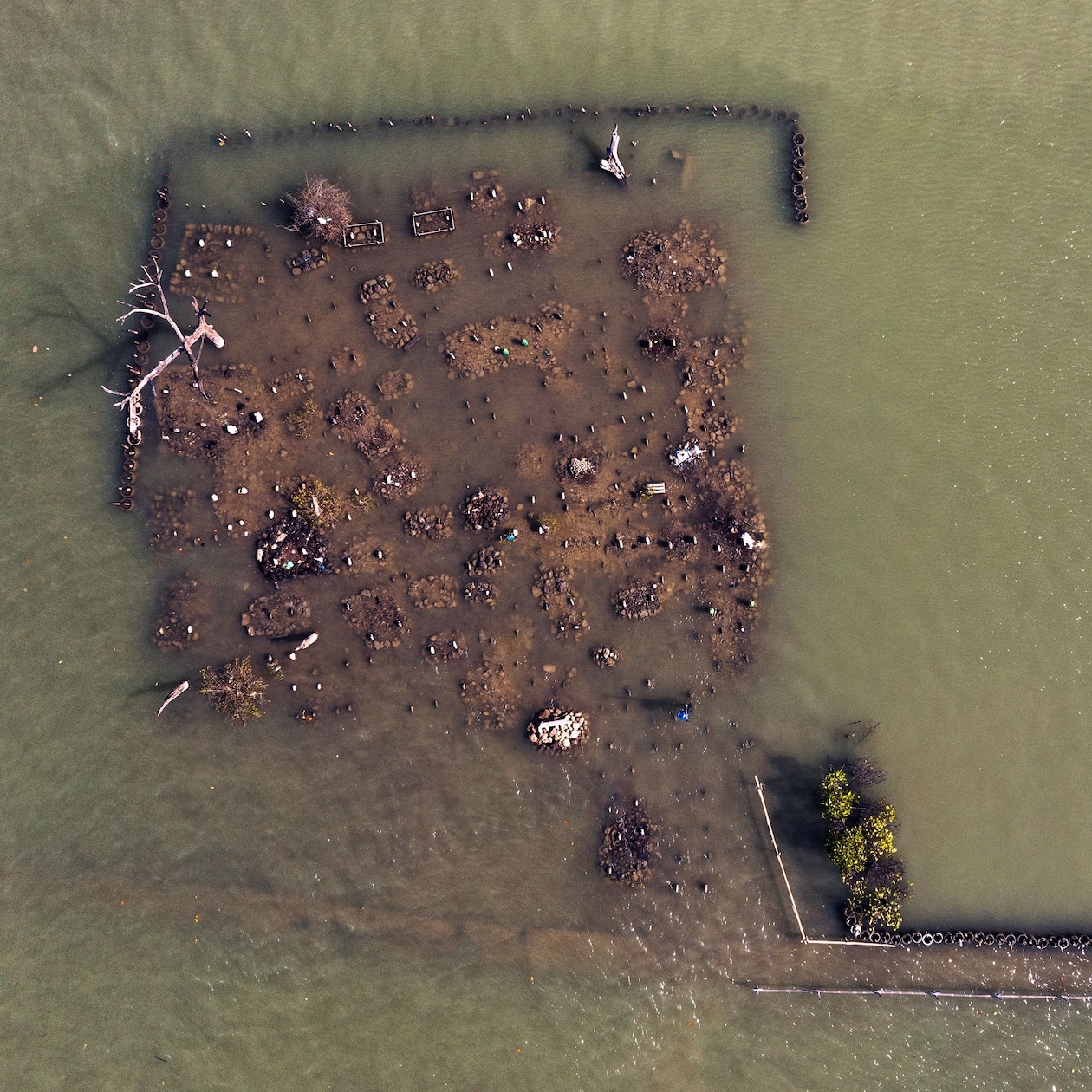 Flooded cemetery on the coast in Central Java, Indonesia.