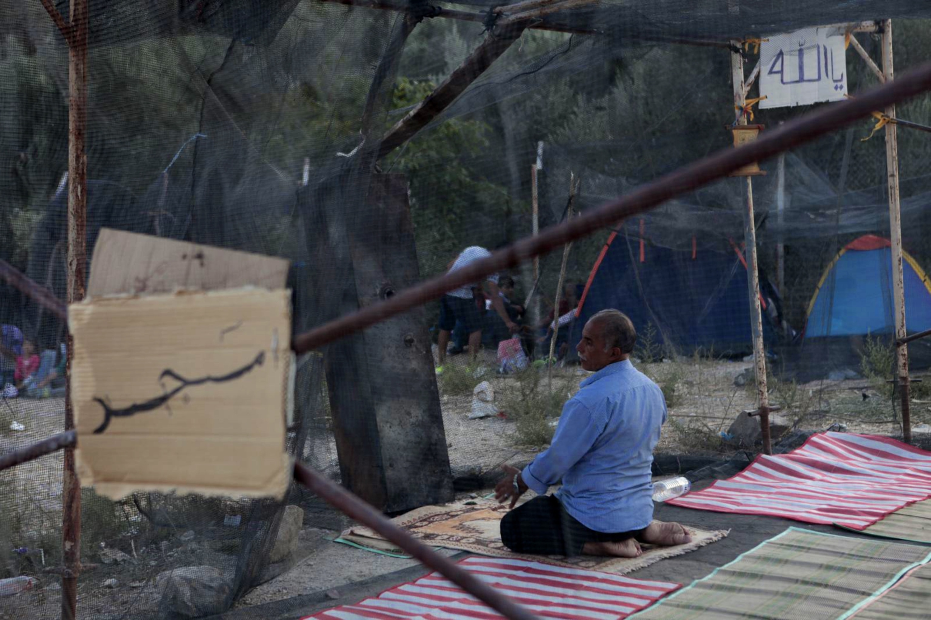 A Pakistani refugee prays