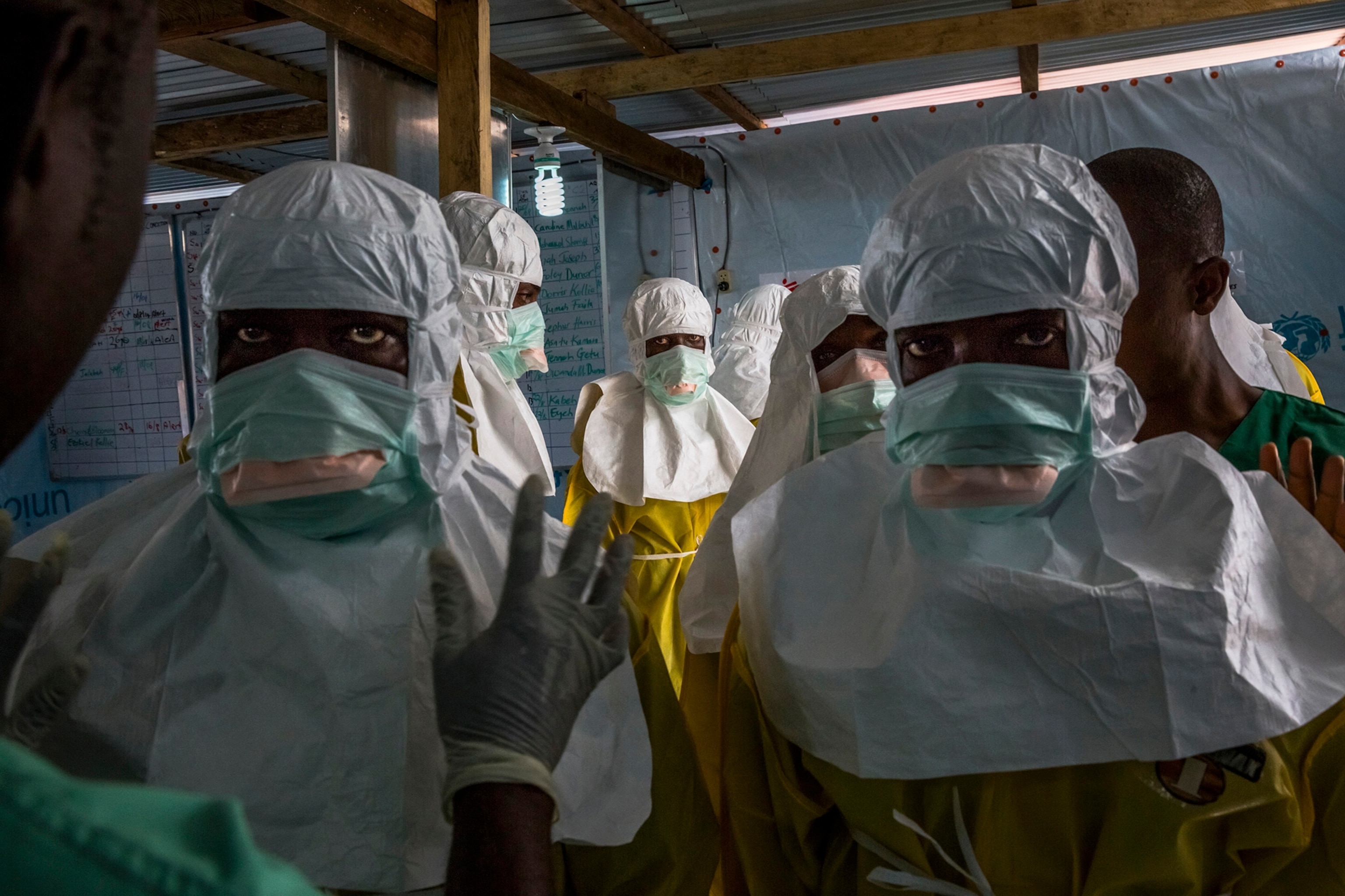 A girl suspected of having Ebola lies on a sidewalk, where her aunt left her after she was unable to get help, in Monrovia, Liberia, Aug. 31, 2014. Liberia remains desperately short on everything needed to halt the spread of Ebola, but an epidemiologist is working block by block to fill a crucial need: the support of residents. (Daniel Berehulak/The New York Times)