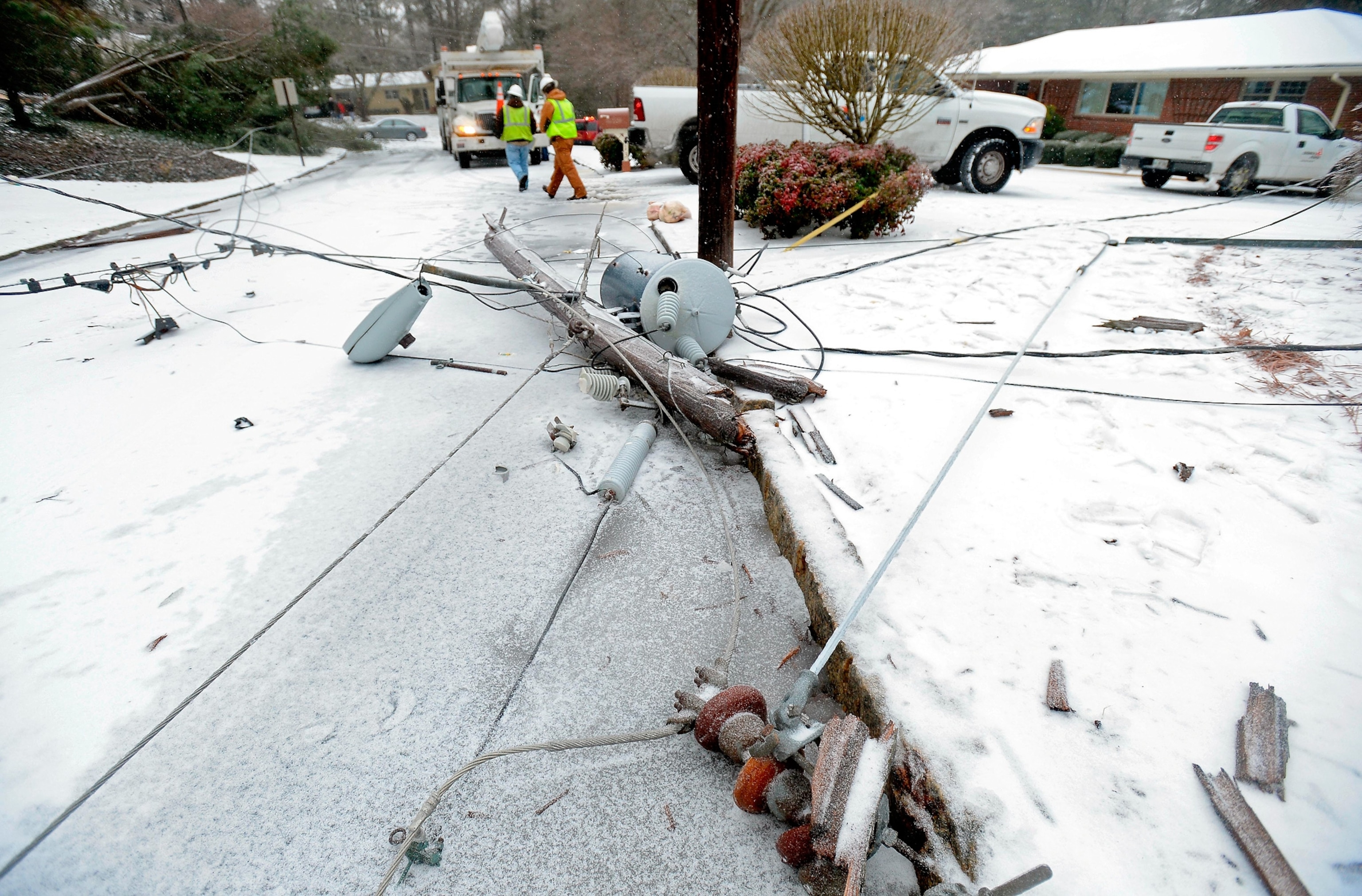 A man braces his umbrella while walking through the snow in NY City.