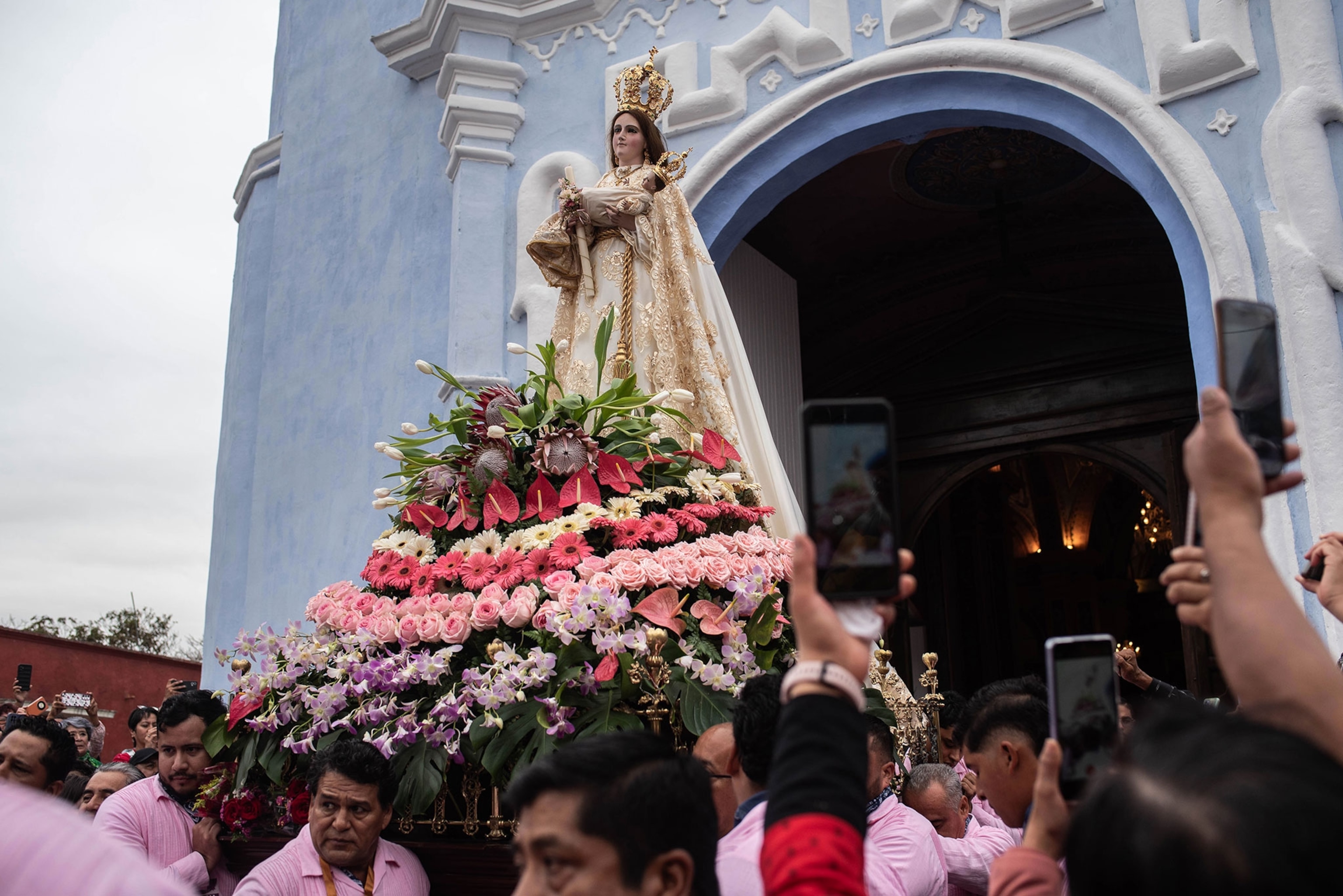 The image of the Virgin of Candelaria is taken out of the church to be carried in a procession as people take pictures with their cellphones during the 'Feast Of The Holy Encounter' celebration in Veracruz, Mexico.