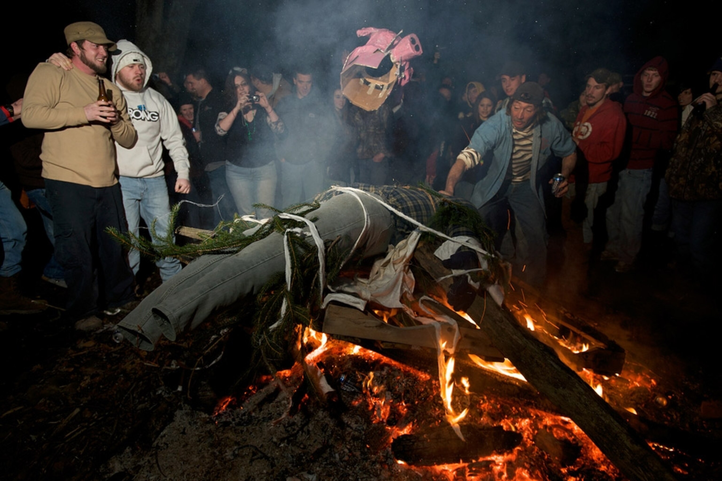 A crowd of people around a bonfire