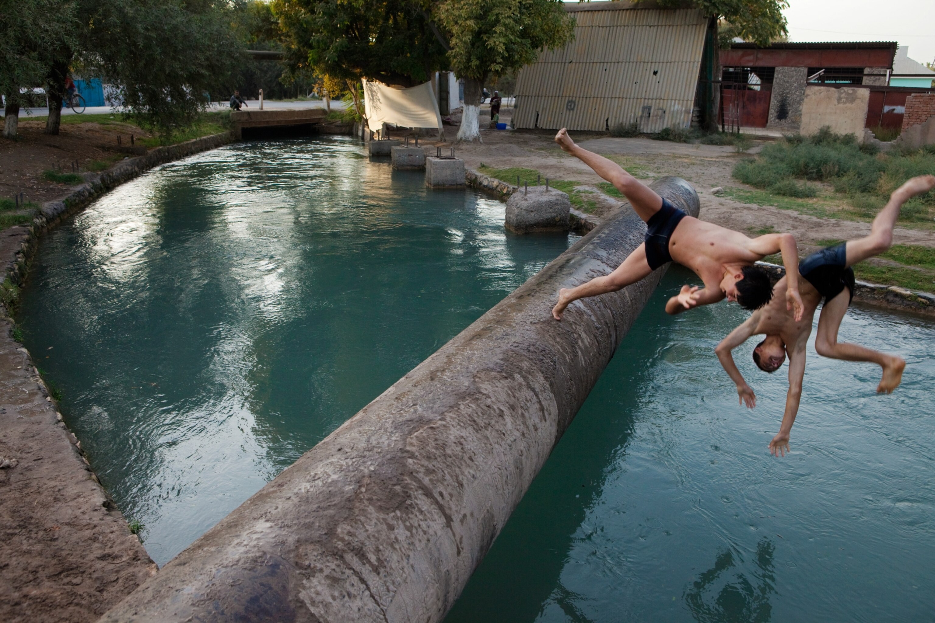 kids jumping into a swimming hole in the village of Ghaira in southwestern Tajikistan
