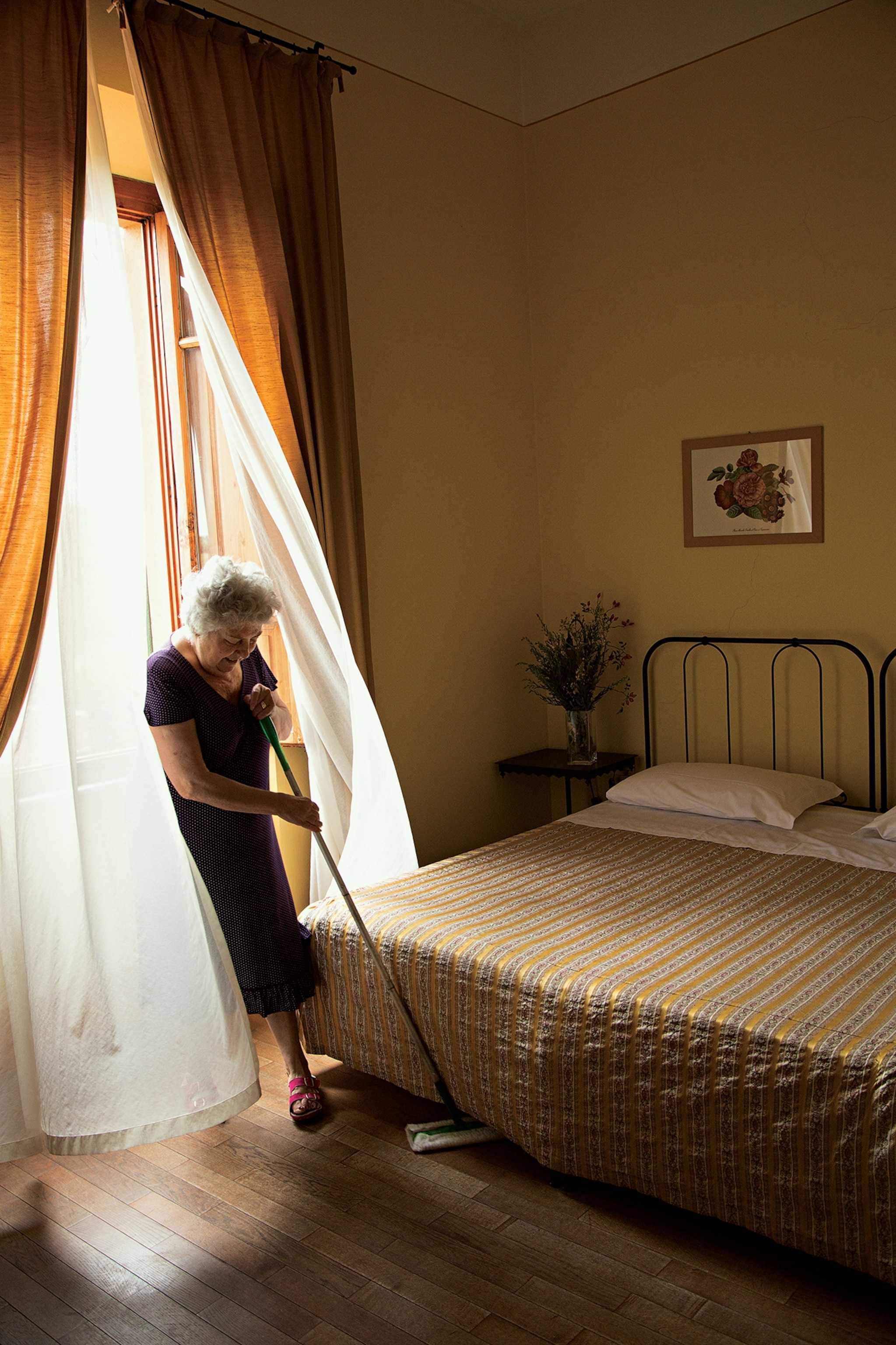 housekeeper Rettori Vanna sweeping at La Locanda di Pietracupa inn, San Donato, Italy