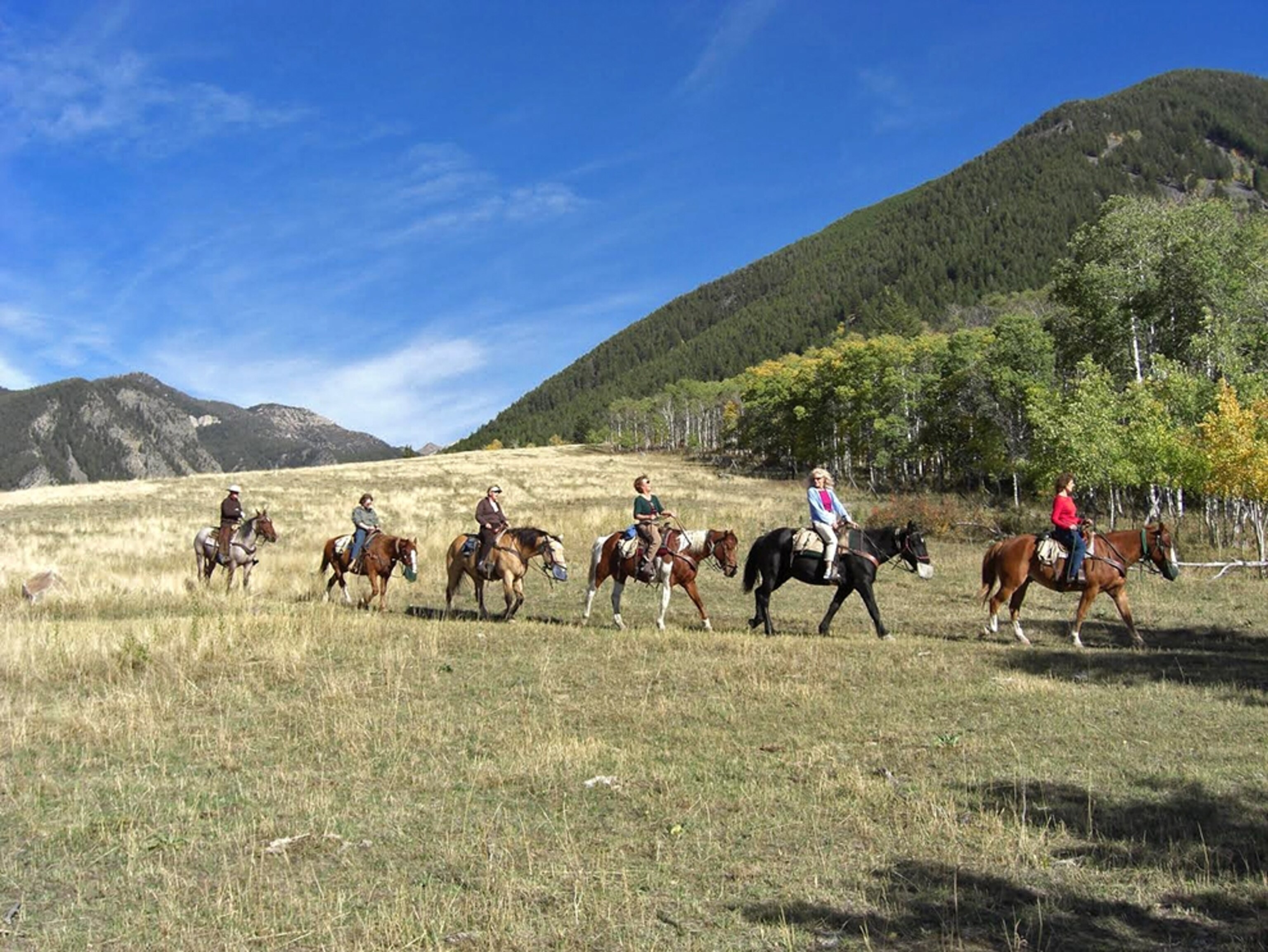 people horseback riding through Montana
