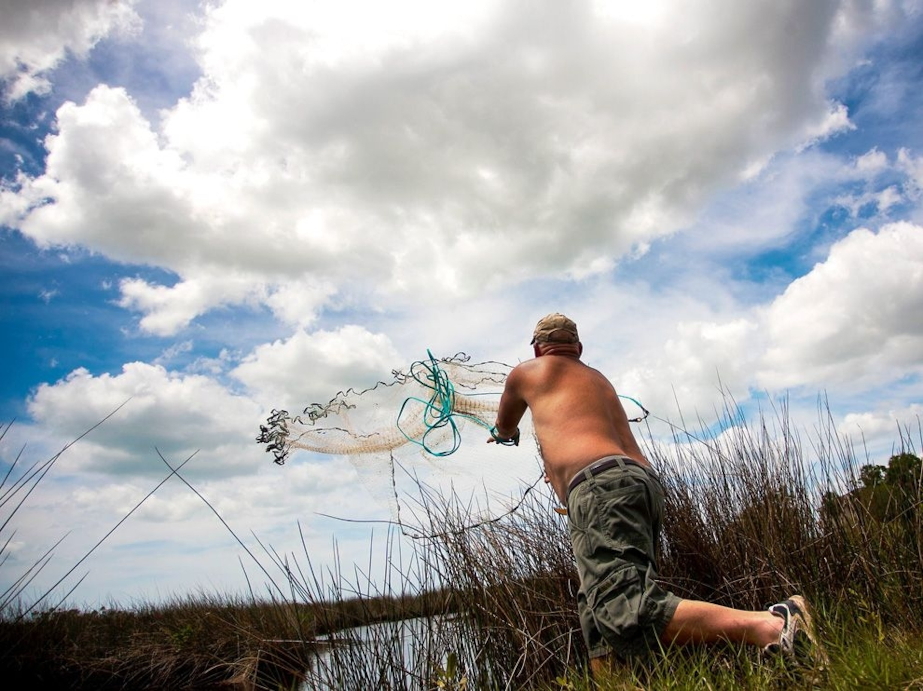 A fisherman casts a net for mullet in Aripeka, a rural area on Florida's west coast.