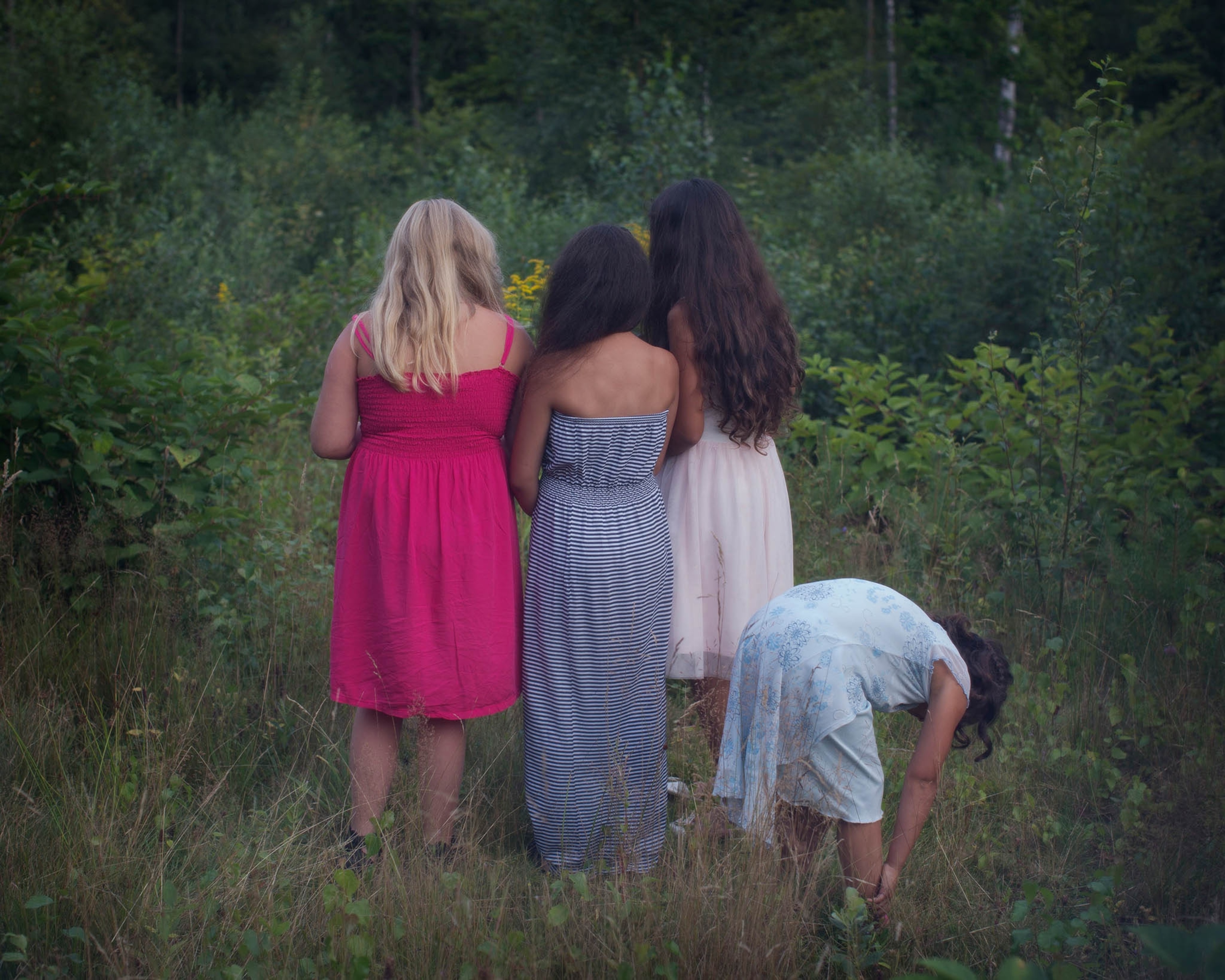 girls in brush picking flowers