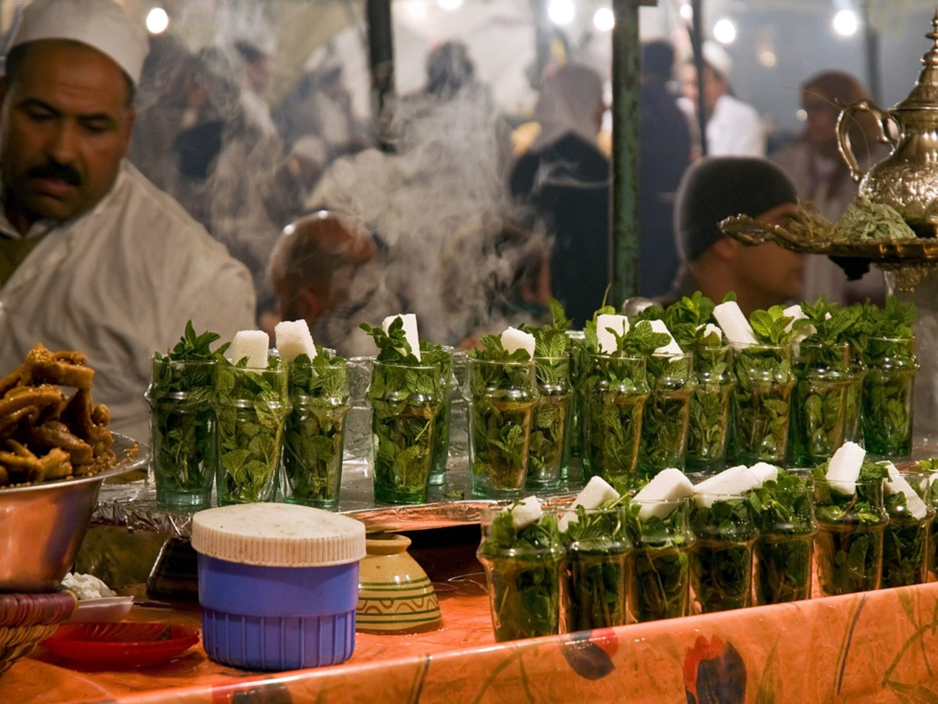 Two dozen glasses, filled with mint by a tea vendor