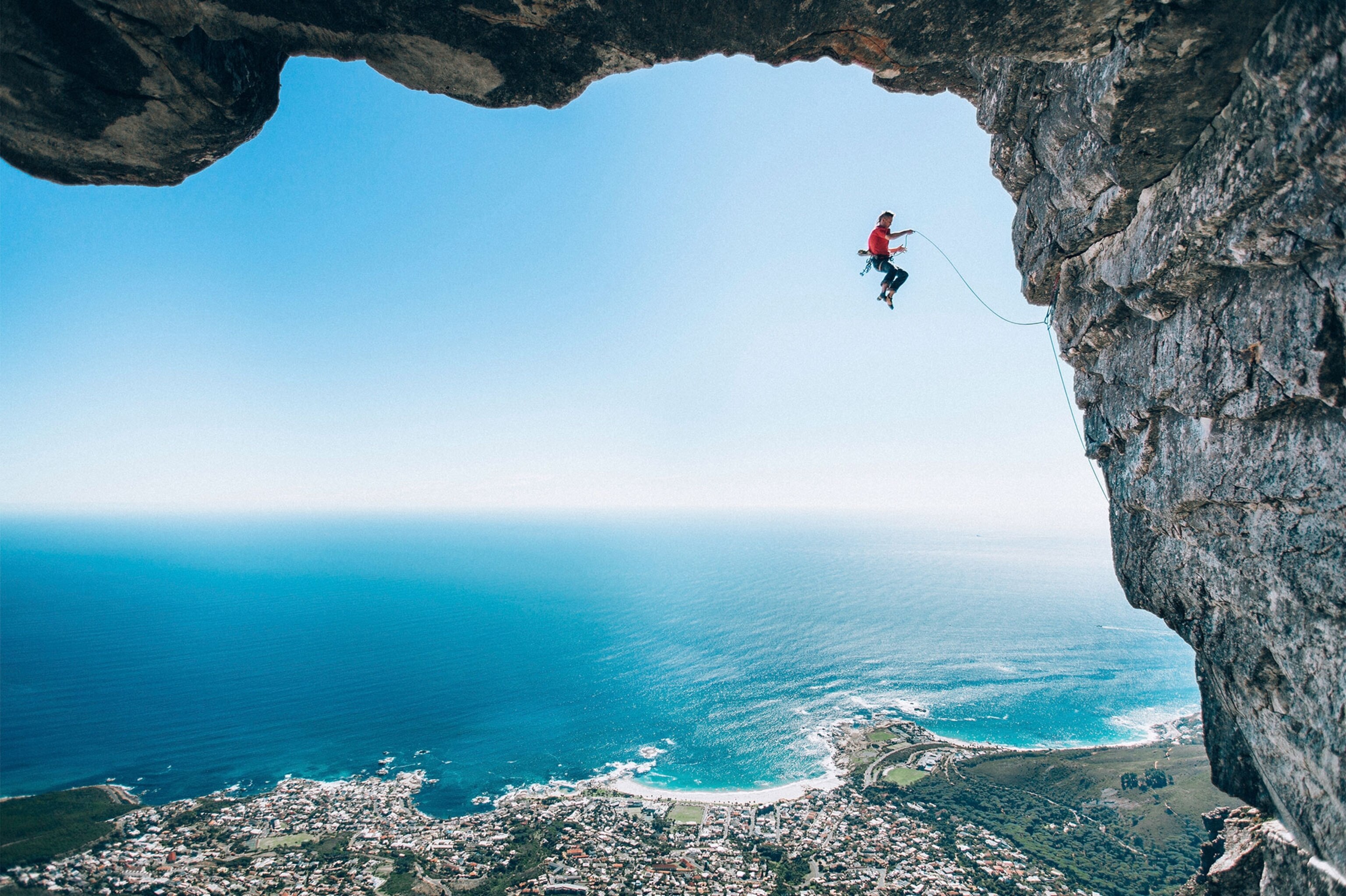 a rock climber falling away from a rock face