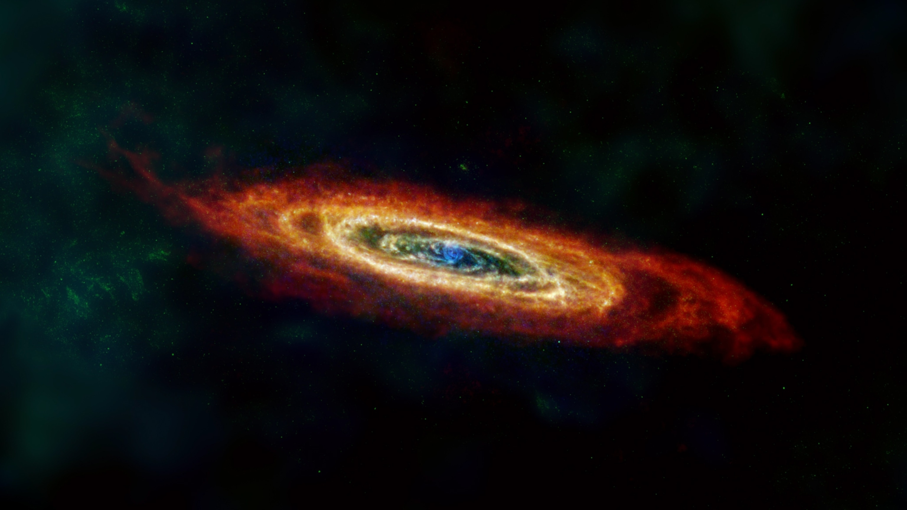 The Andromeda galaxy, which appears as a vortex shape with swirls of blue and green at the center, which changes to shades of yellow, orange, and red the further the swirls stray from the center.