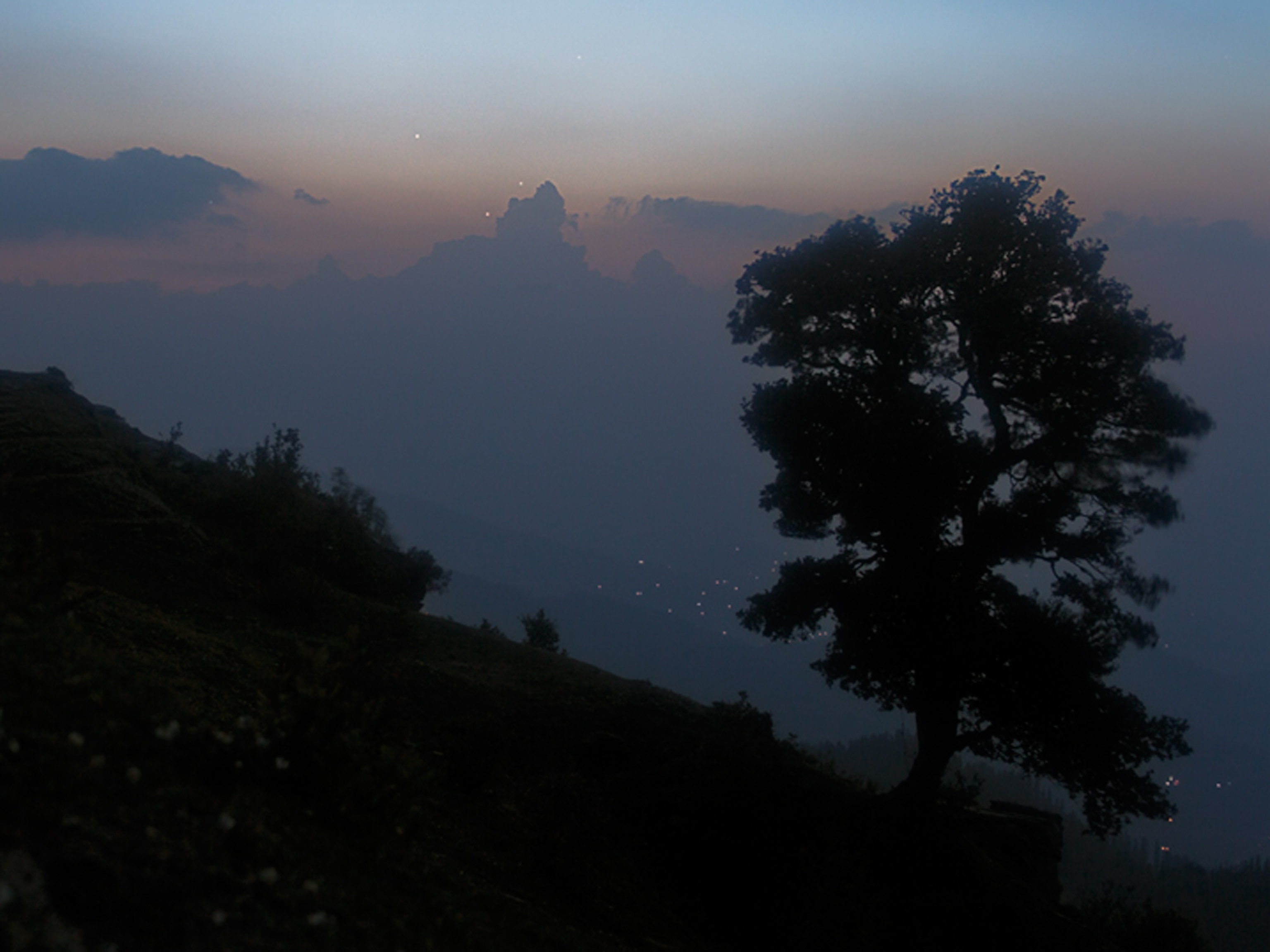Venus, Mercury, and Jupiter converging in a triangle in the skies near the Himalayas