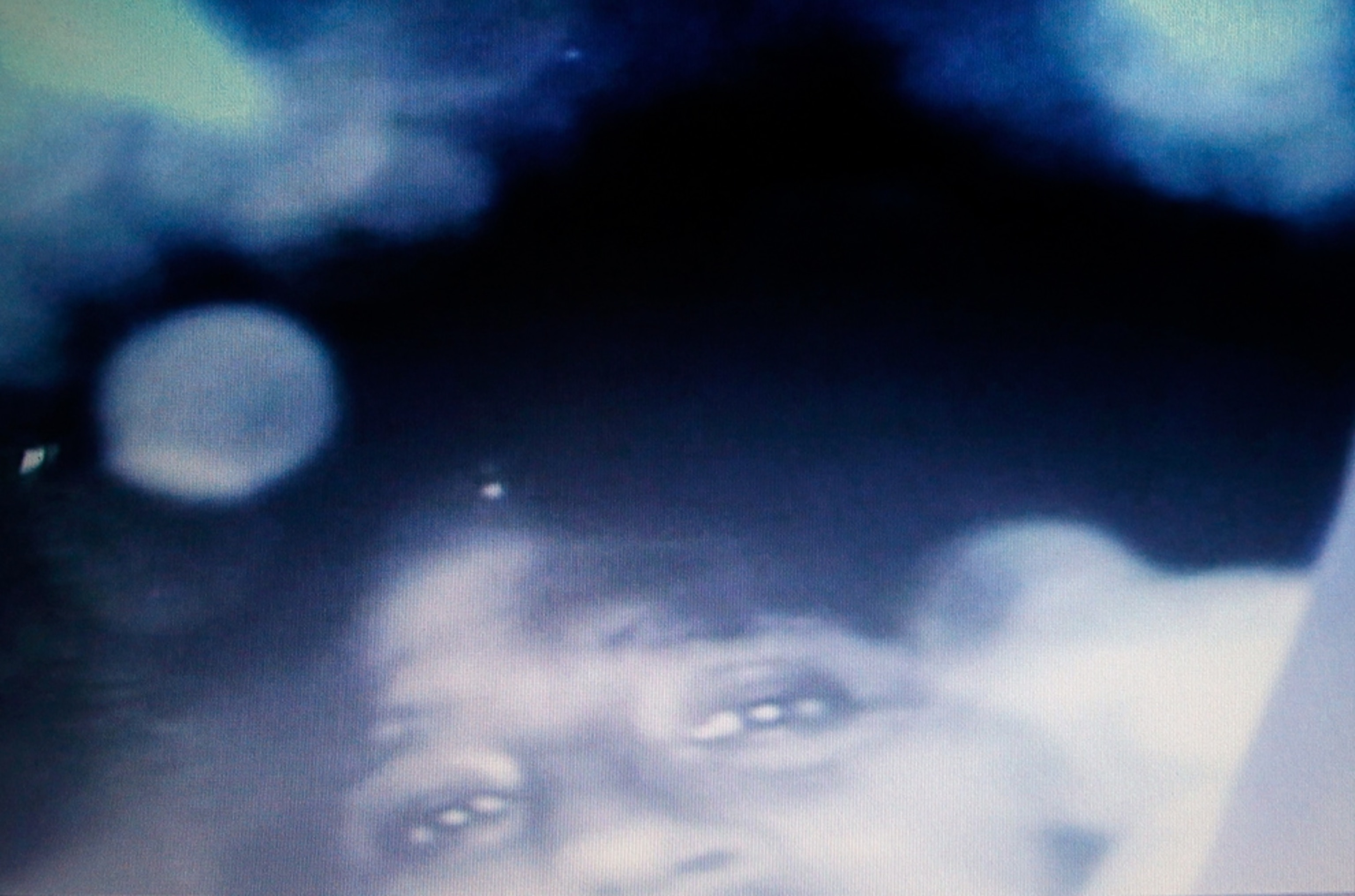 A computer screen shows a recorded image of a trapped miner.