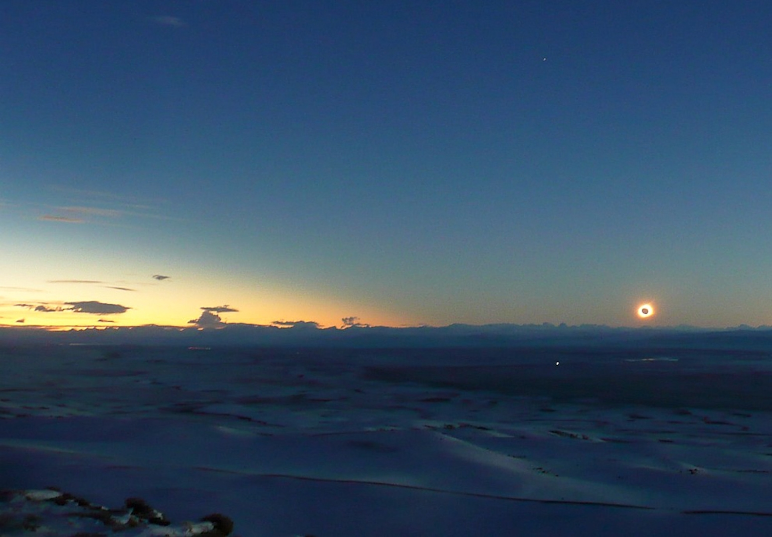 Picture of the solar eclipse seen over the snowy plains of the Patagonia region in southern Argentina.