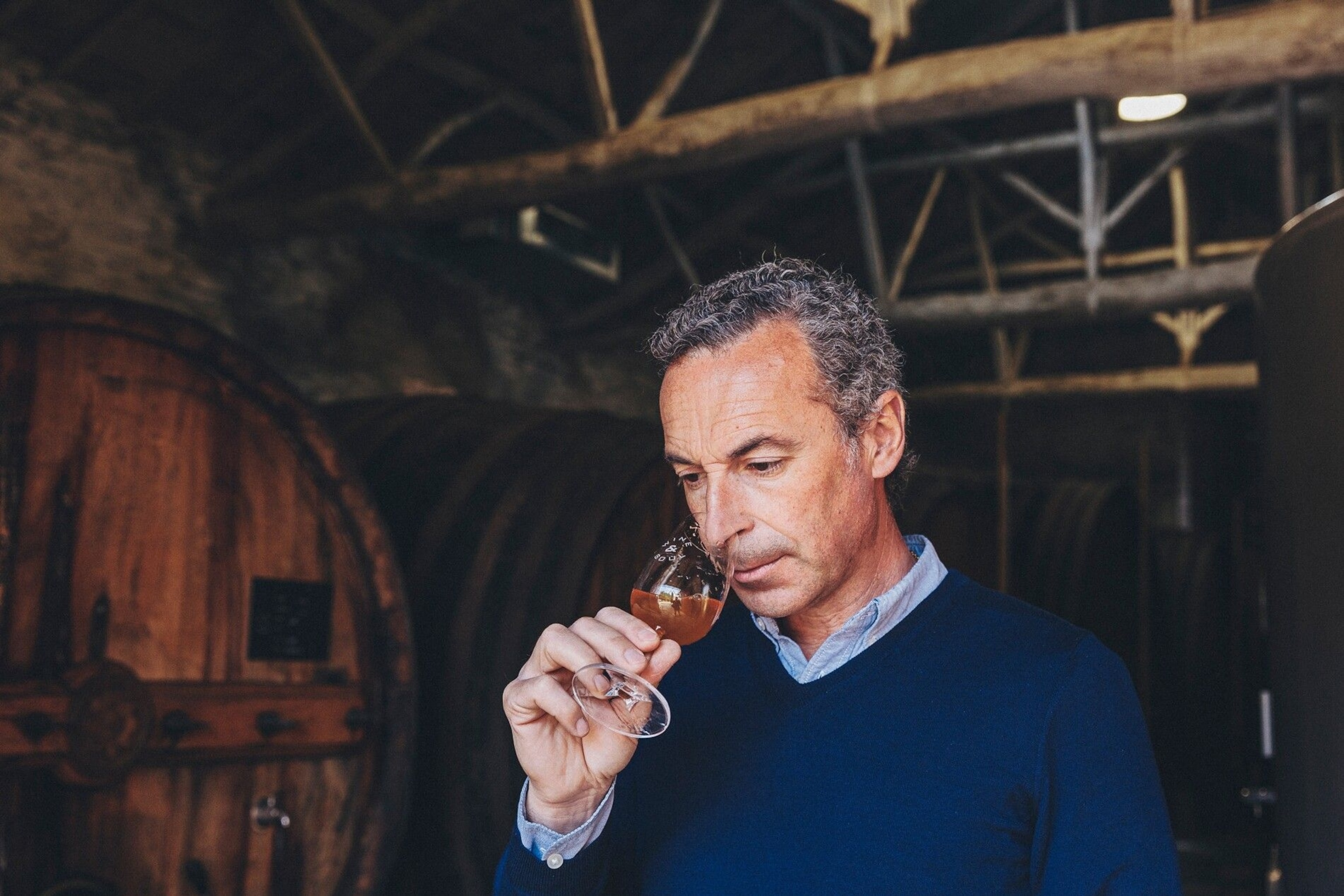 Man samples a glass of port