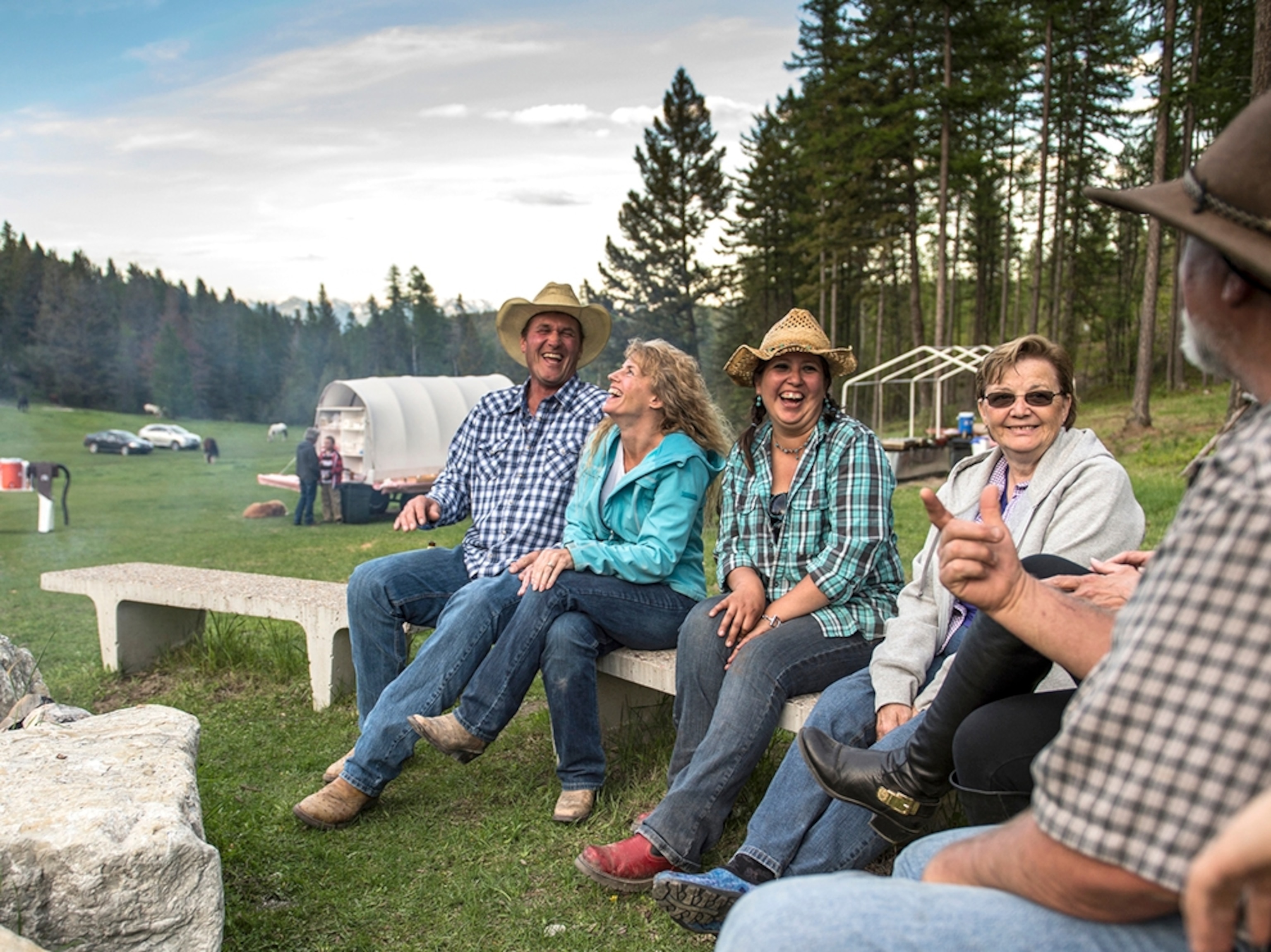 people sitting around a campfire at Artemis Acres Paint Horse Guest Ranch in Kalispell, Montana