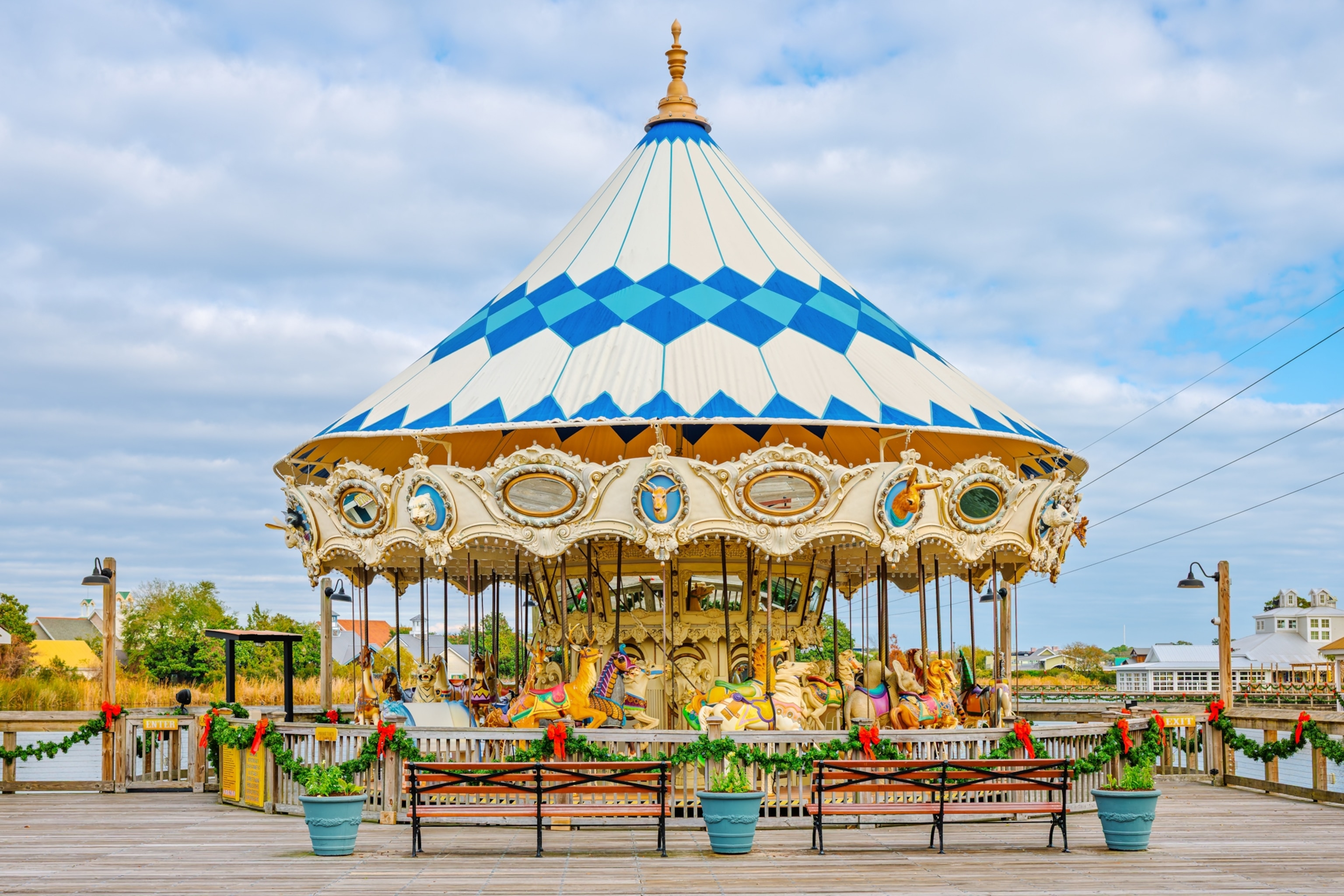 Colorful wooden carved horses and other animals on the waterfront boardwalk carousel in Myrtle Beach, South Carolina.