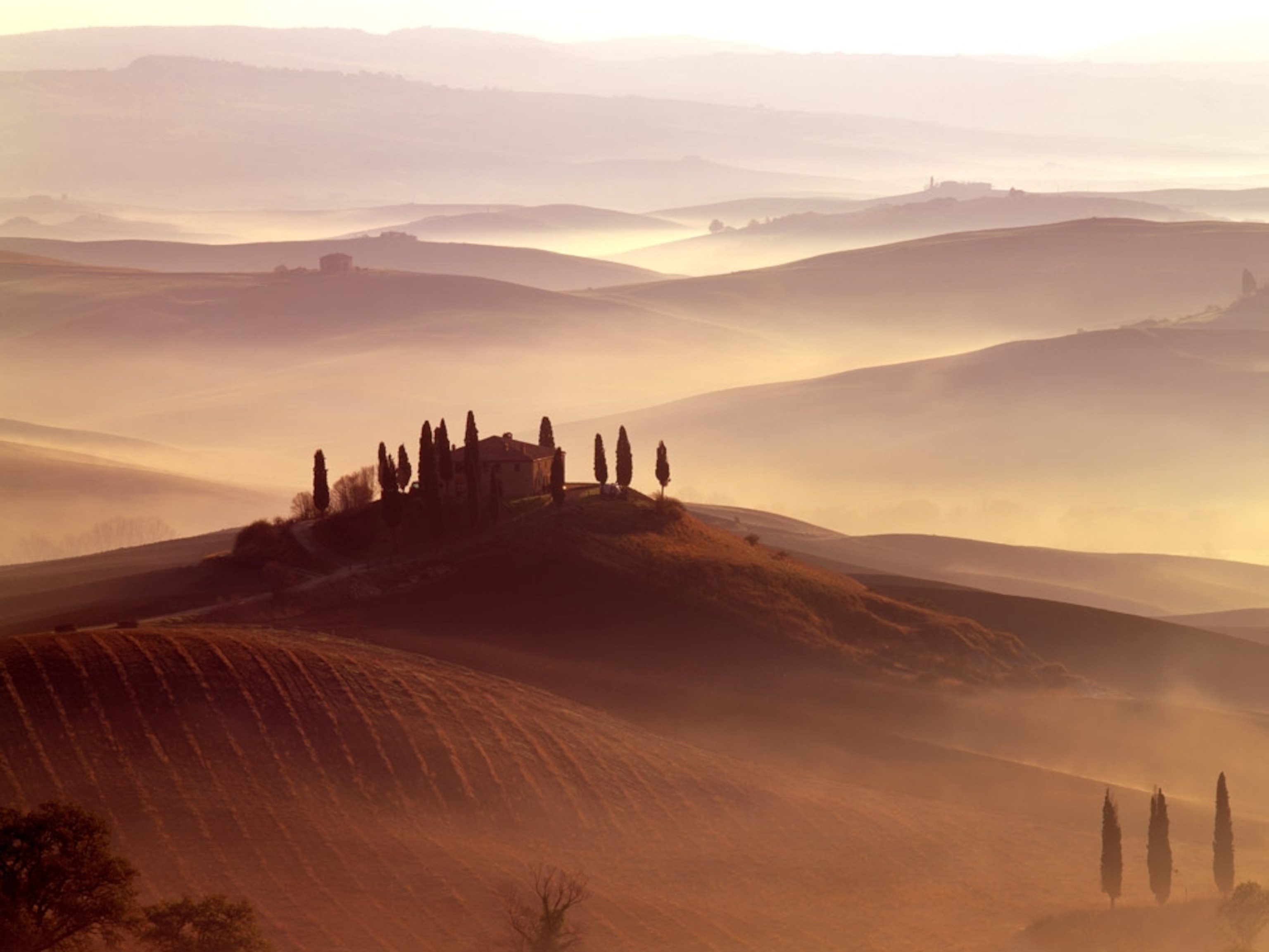 A house sitting on top of rolling hills