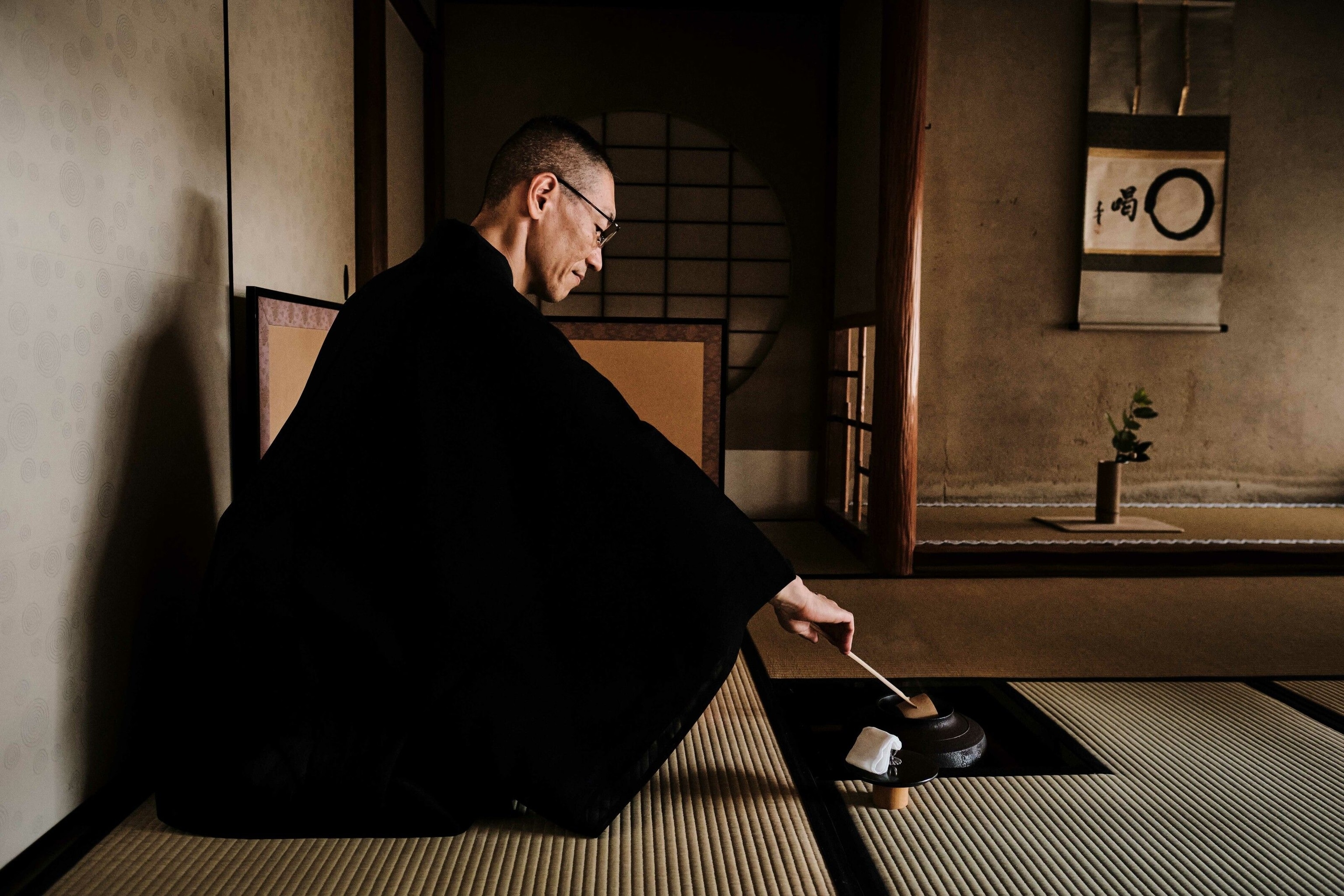 A man sat on the floor burning incense.