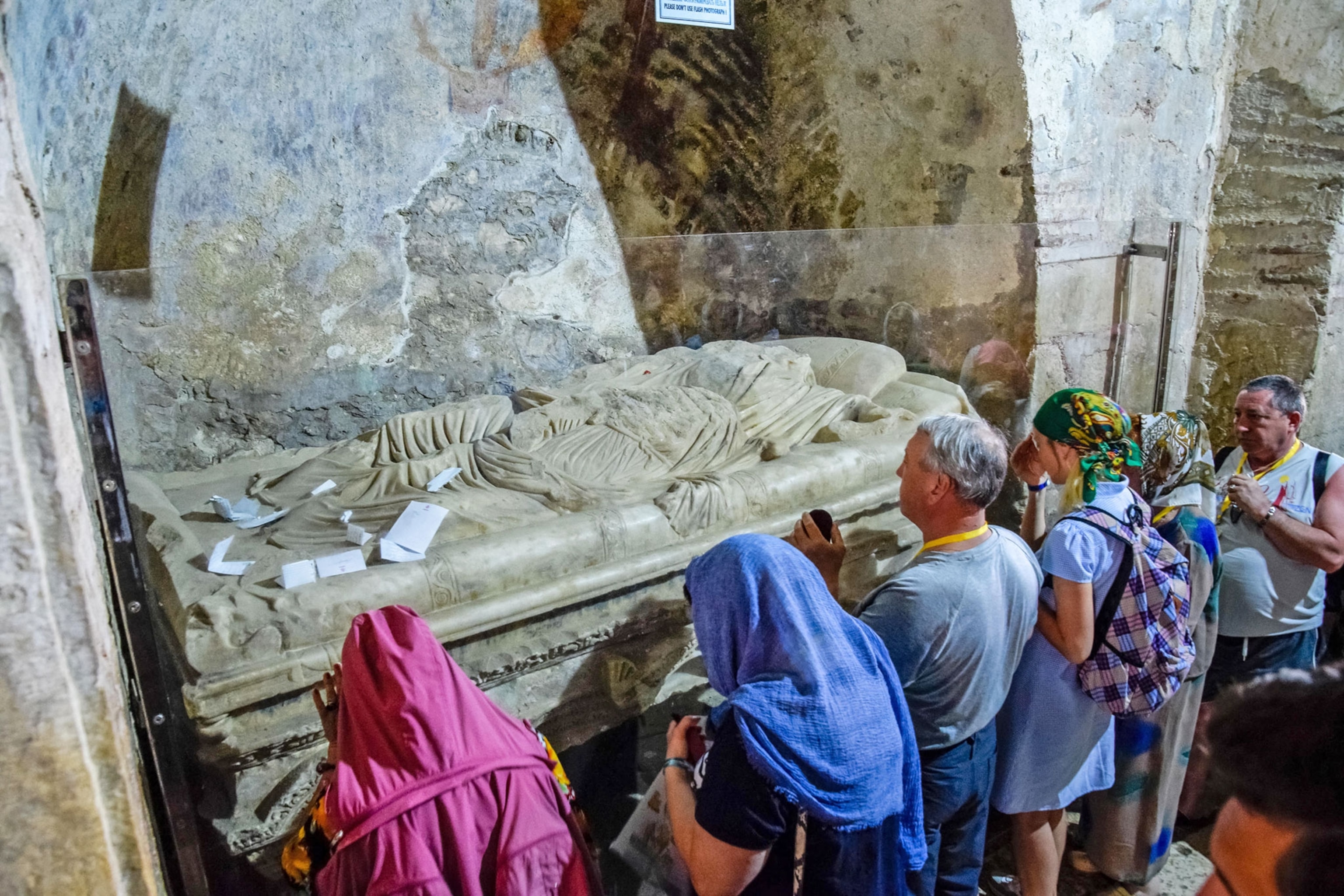 Pilgrims near the sarcophagus of St. Nicholas in Demre, Türkiye.