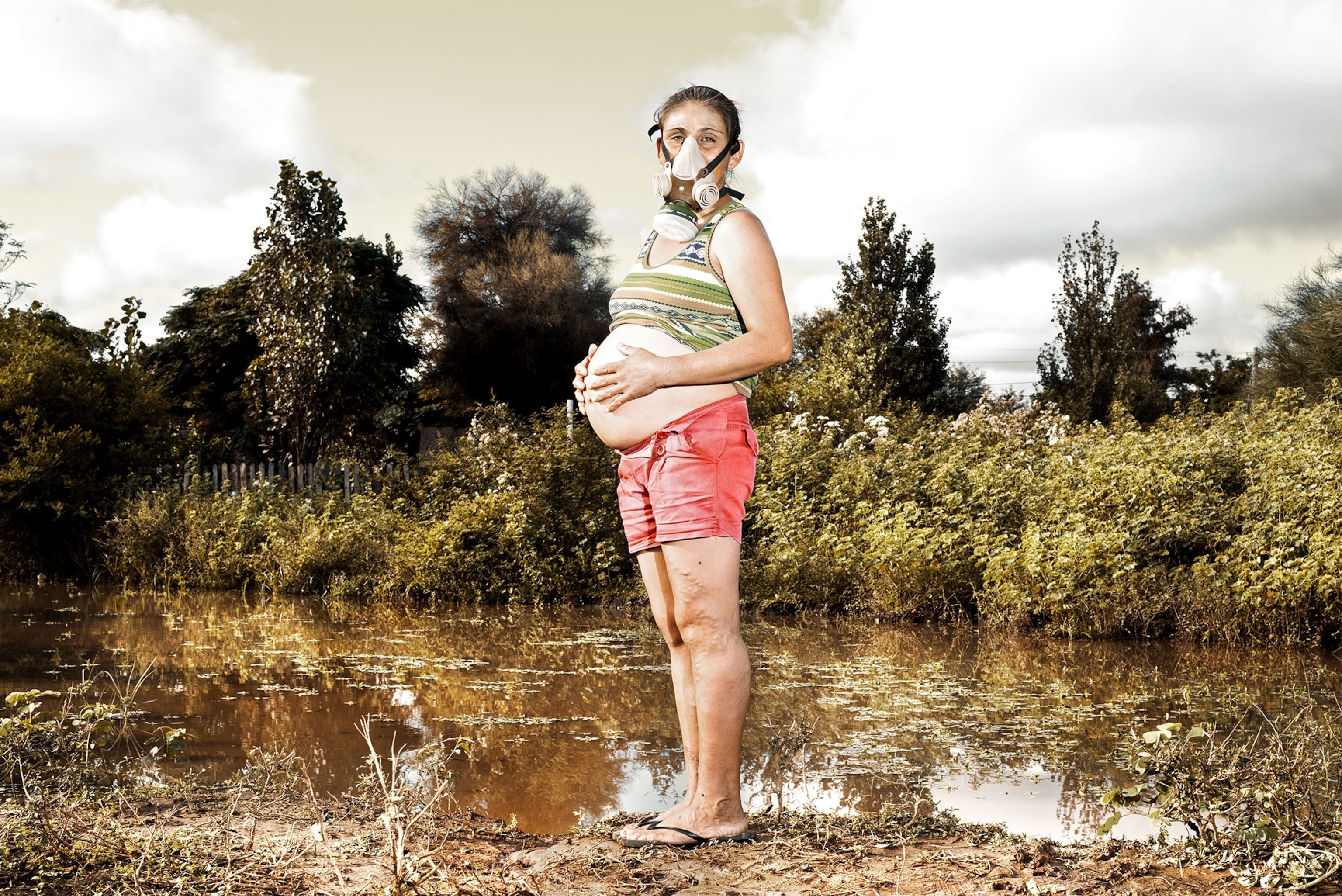 a pregnant woman wearing a respirator.