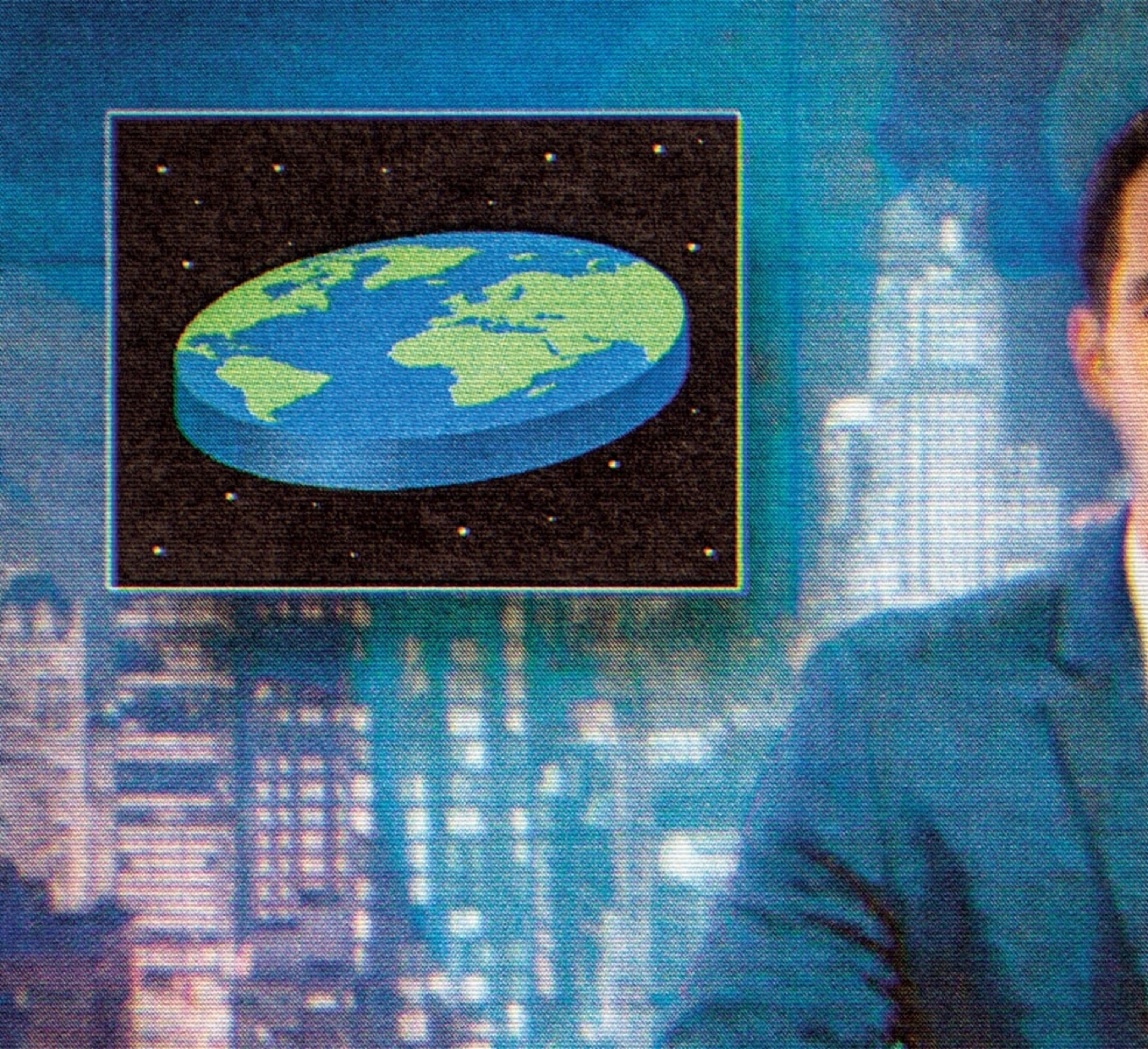 a man hosting a late night program with an icon of a flat earth