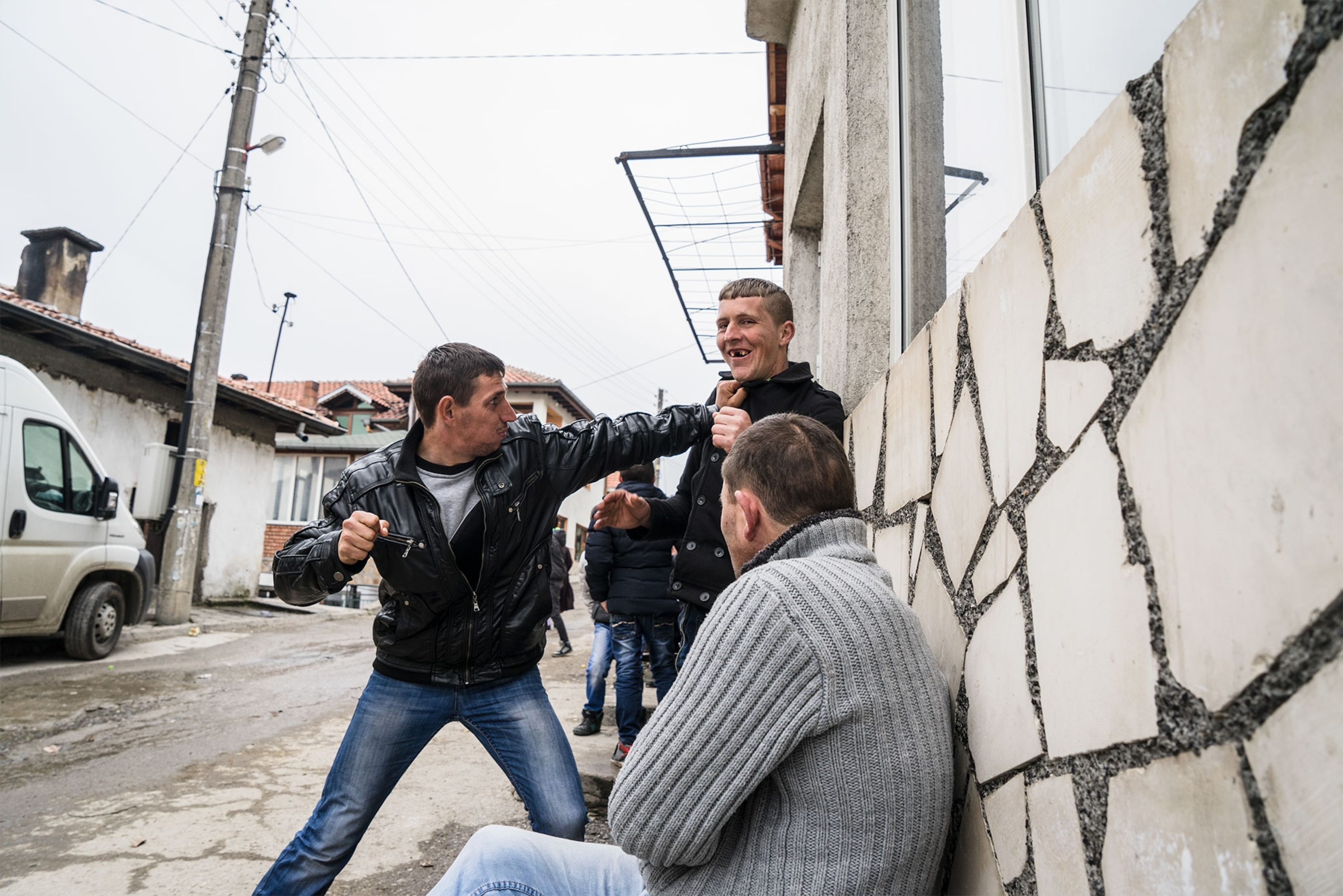 young mean fighting in the street