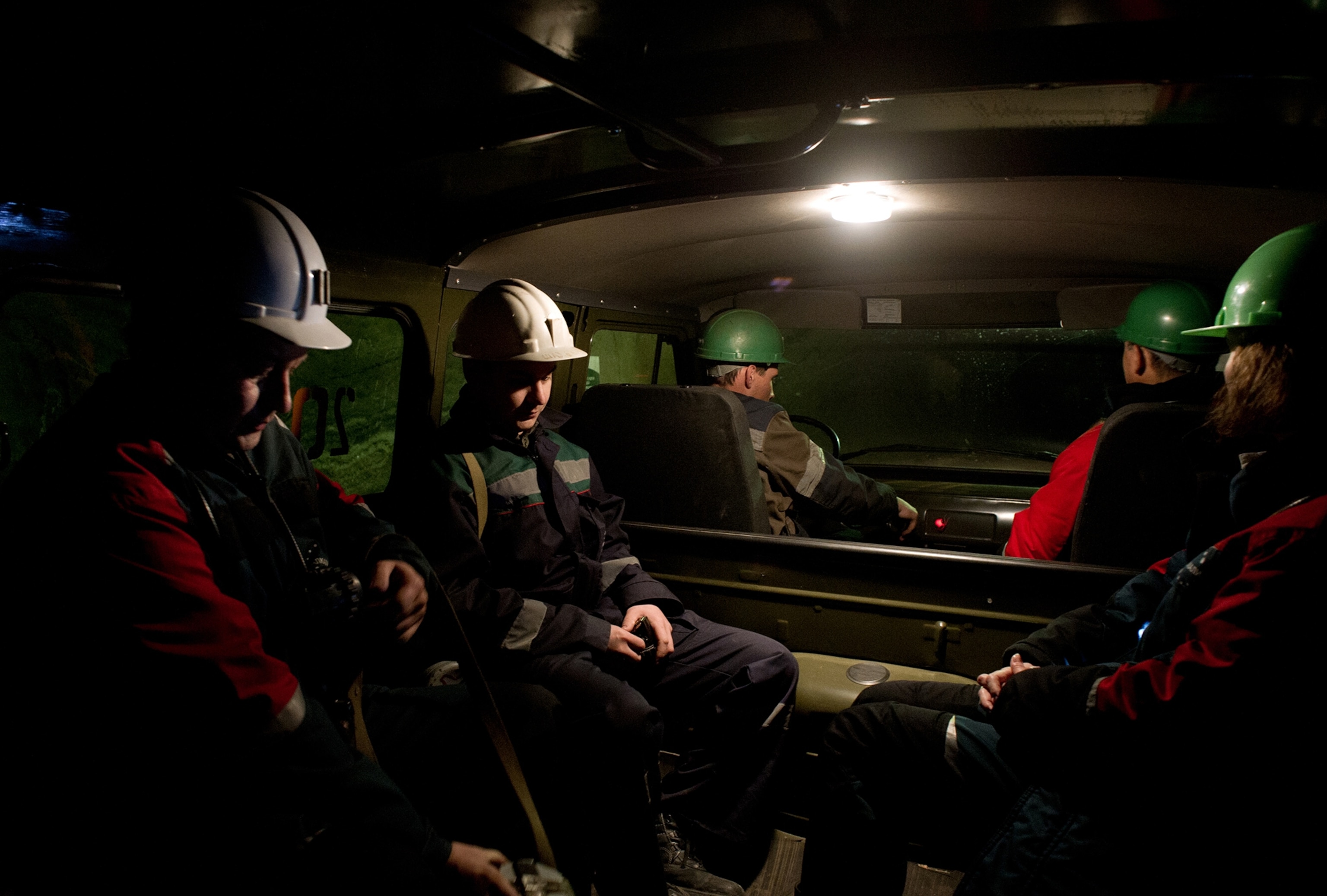 mine workers sitting in a vehicle