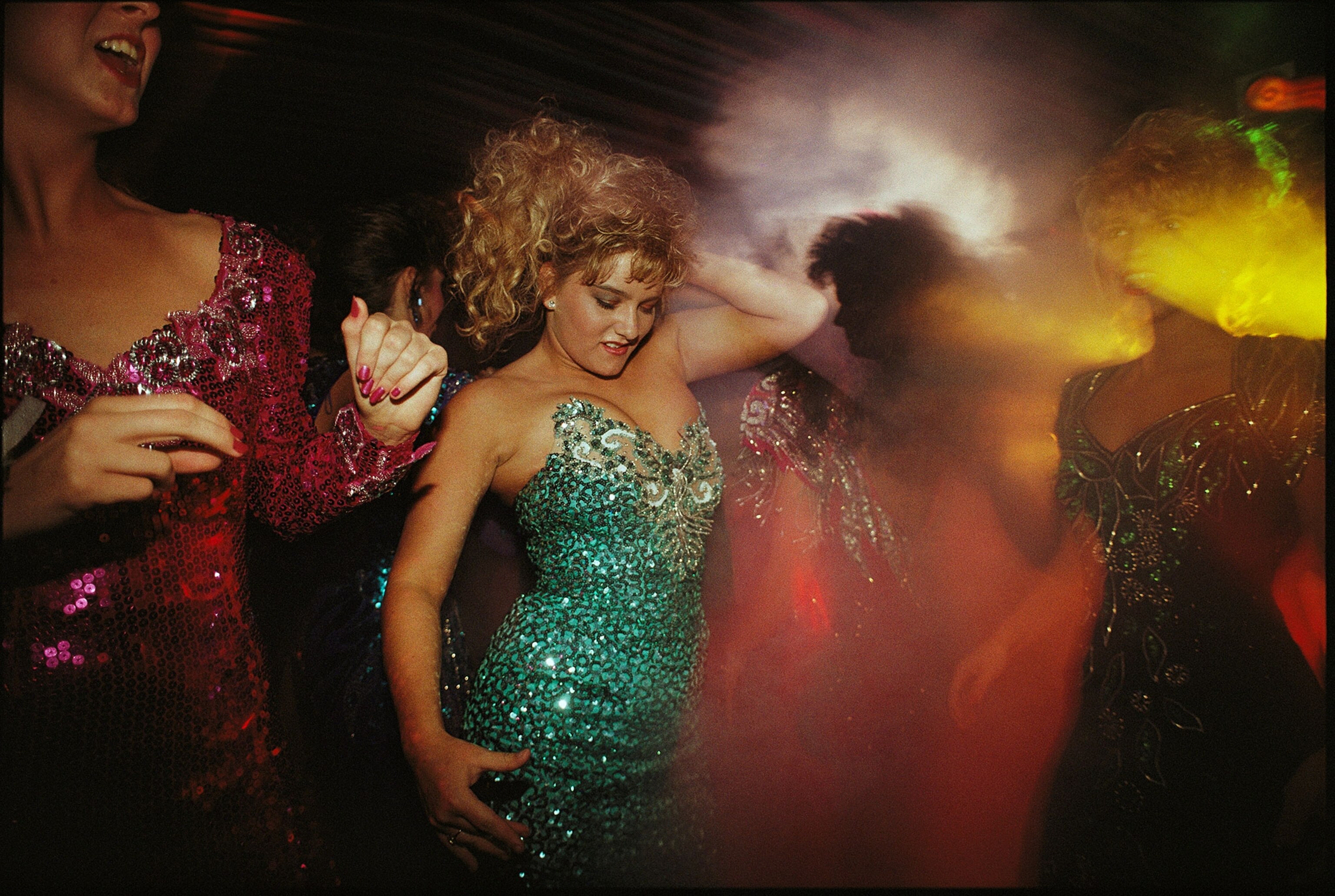 teenage girls dancing in evening gowns at a prom in Stearns, Ky