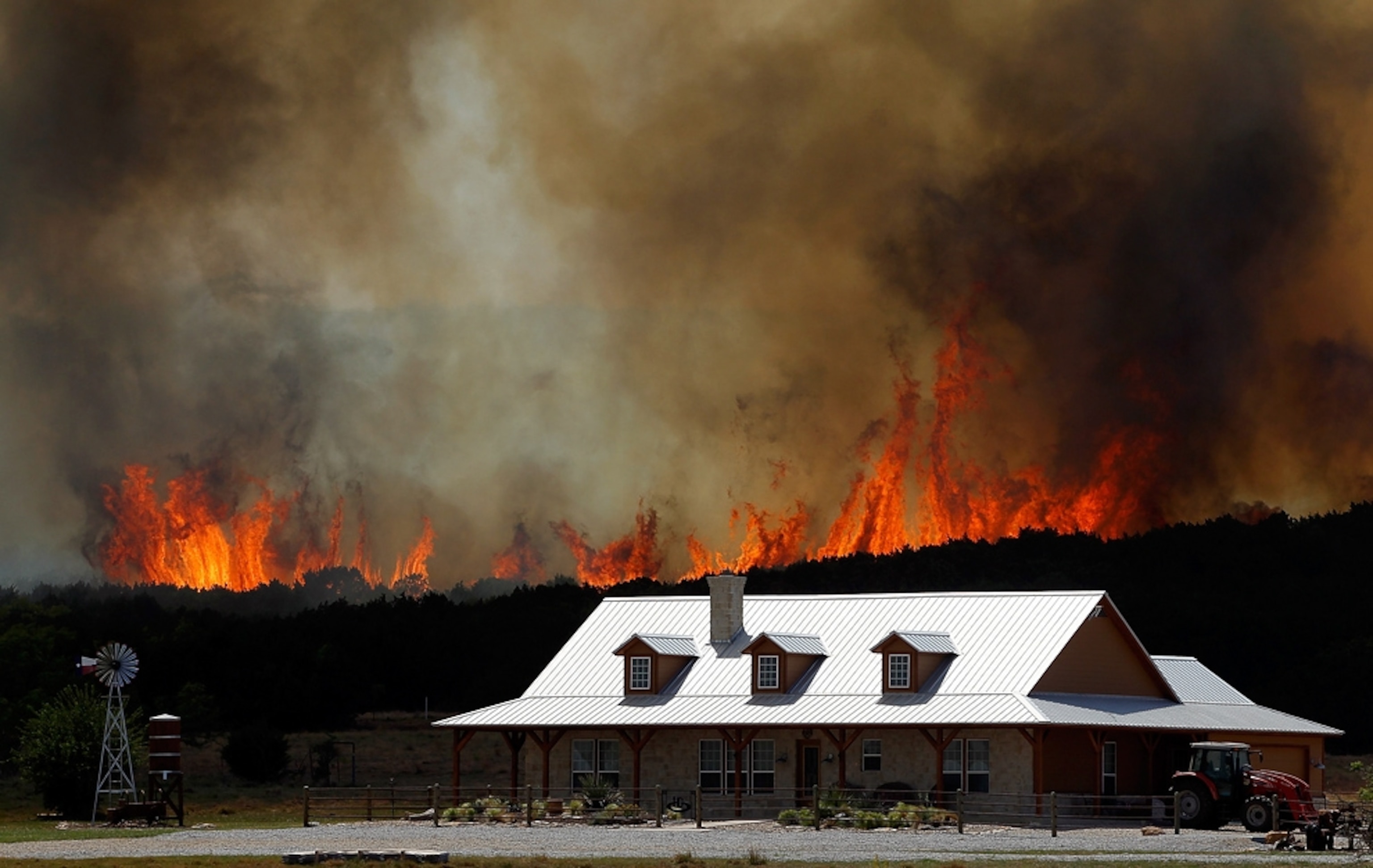 Texas wildfire picture: Flames encroaching on a house near Fort Worth