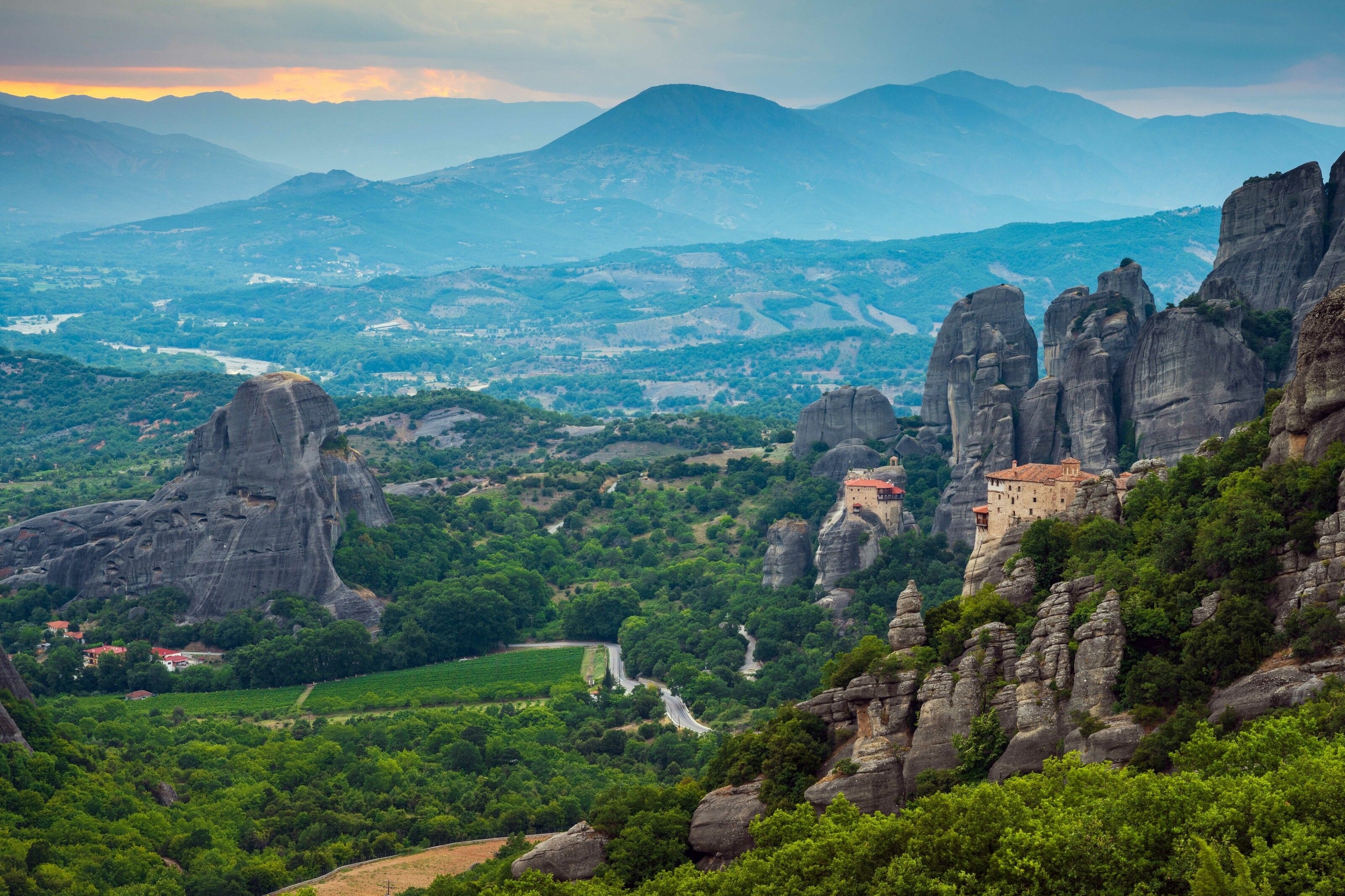 Monasteries and cliffs blend into one another, which is arguably the chief accomplishment of the architecture. The stone of the buildings is lighter than the dark cliffs, but otherwise they would be camouflaged as the shapes compliment the steep natural rock formations, which are plentiful.