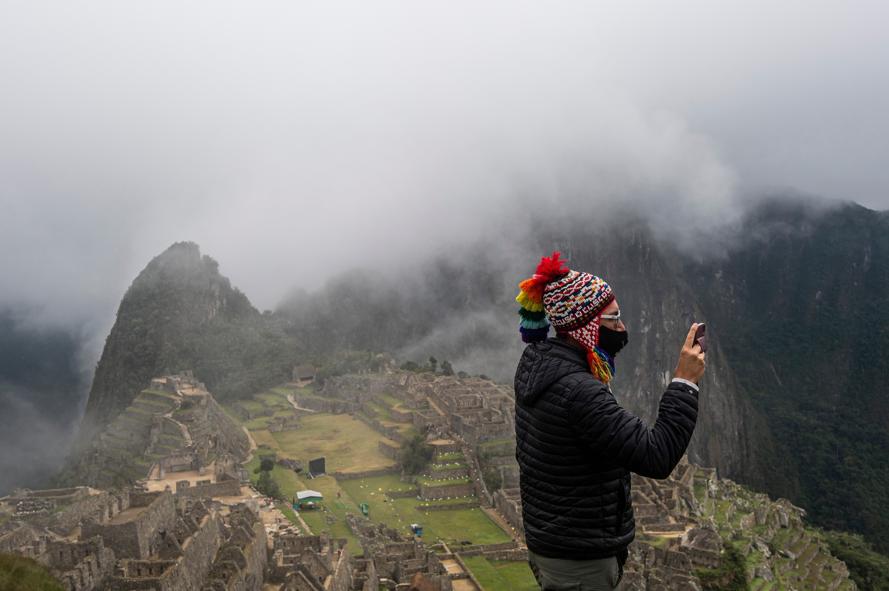 a single tourist makes a photo at Machu Picchu