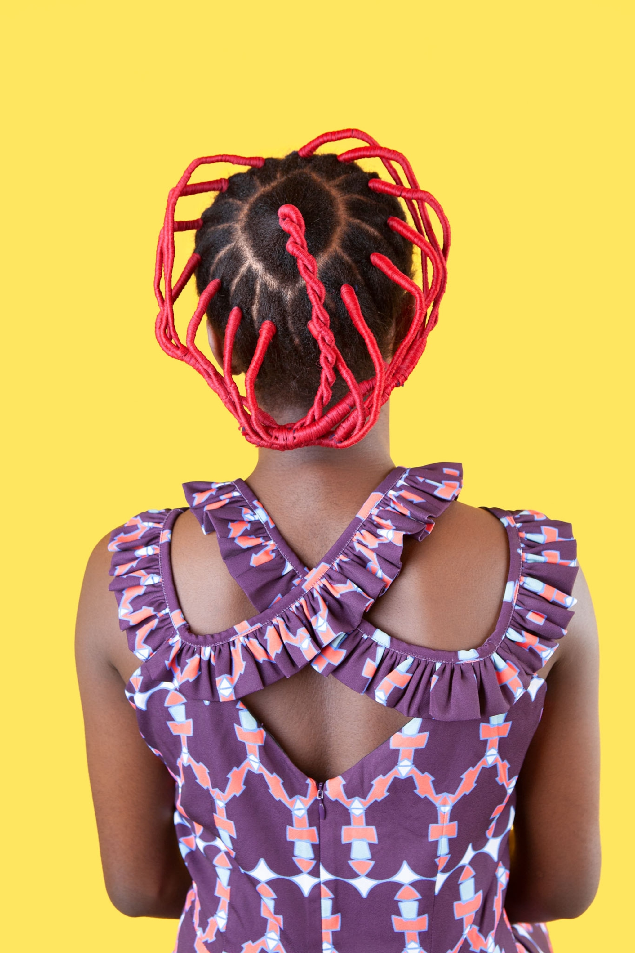 Picture of woman with red thread adding to her hairdo.