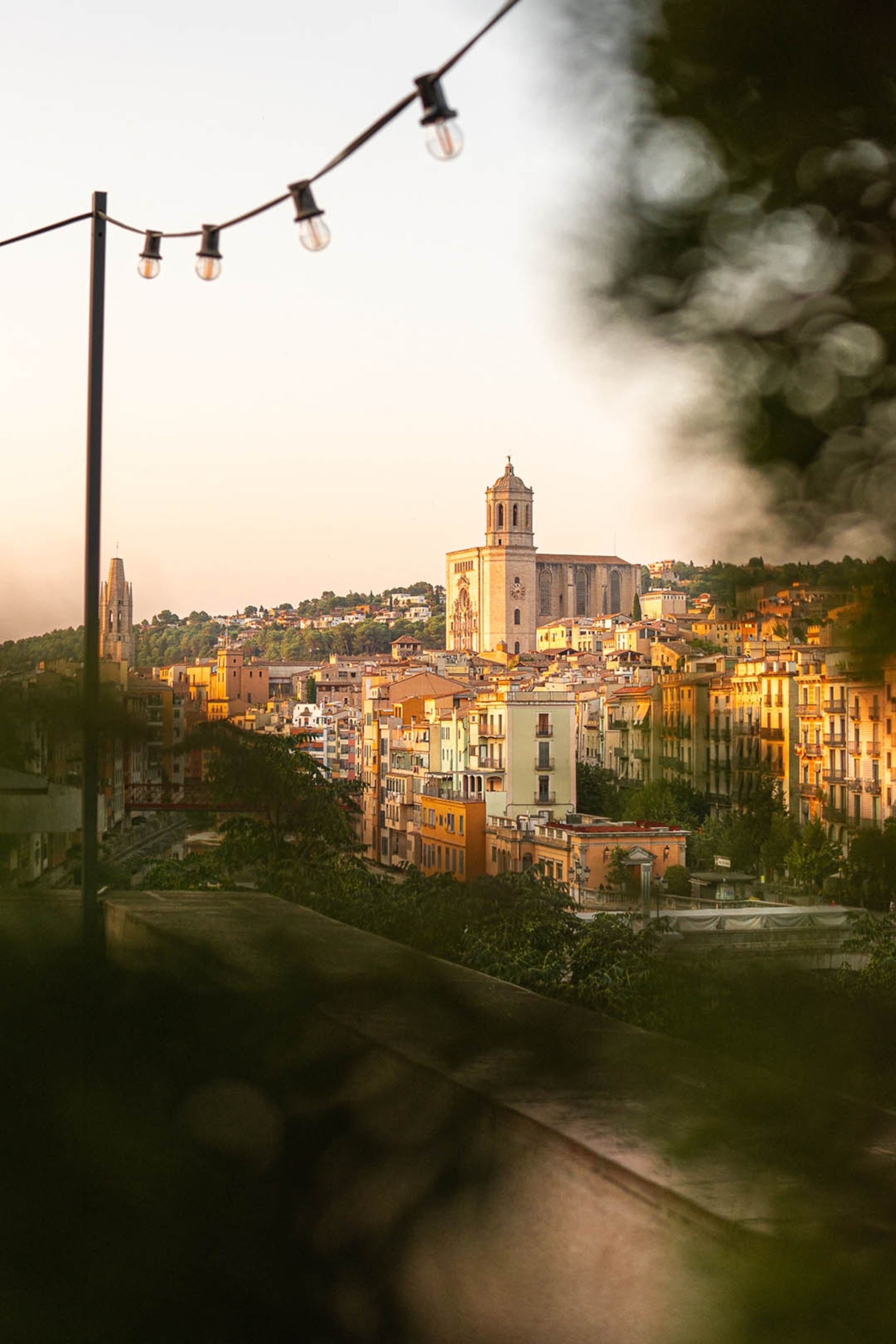 The views over a sun-drenched city in Spain from a terrace.