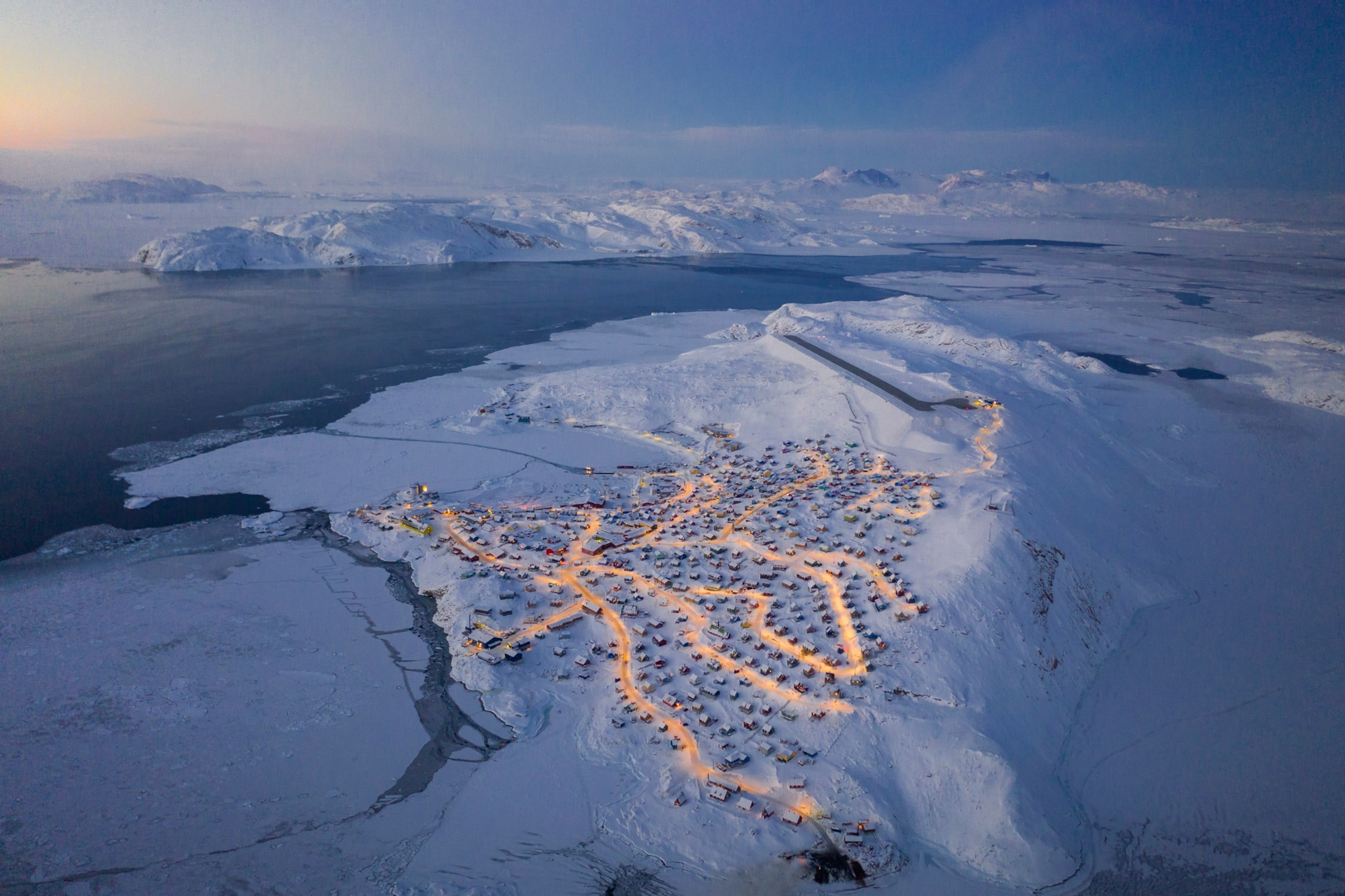 homes lit at night in Upernavik, Greenland