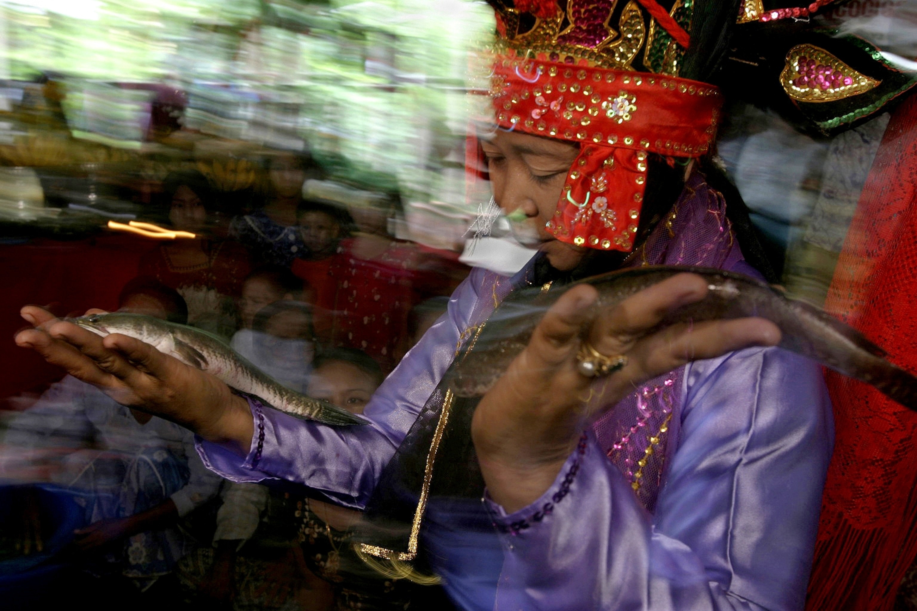 a woman from the town of Pyay appeasing the River Spirit with a traditional blessing