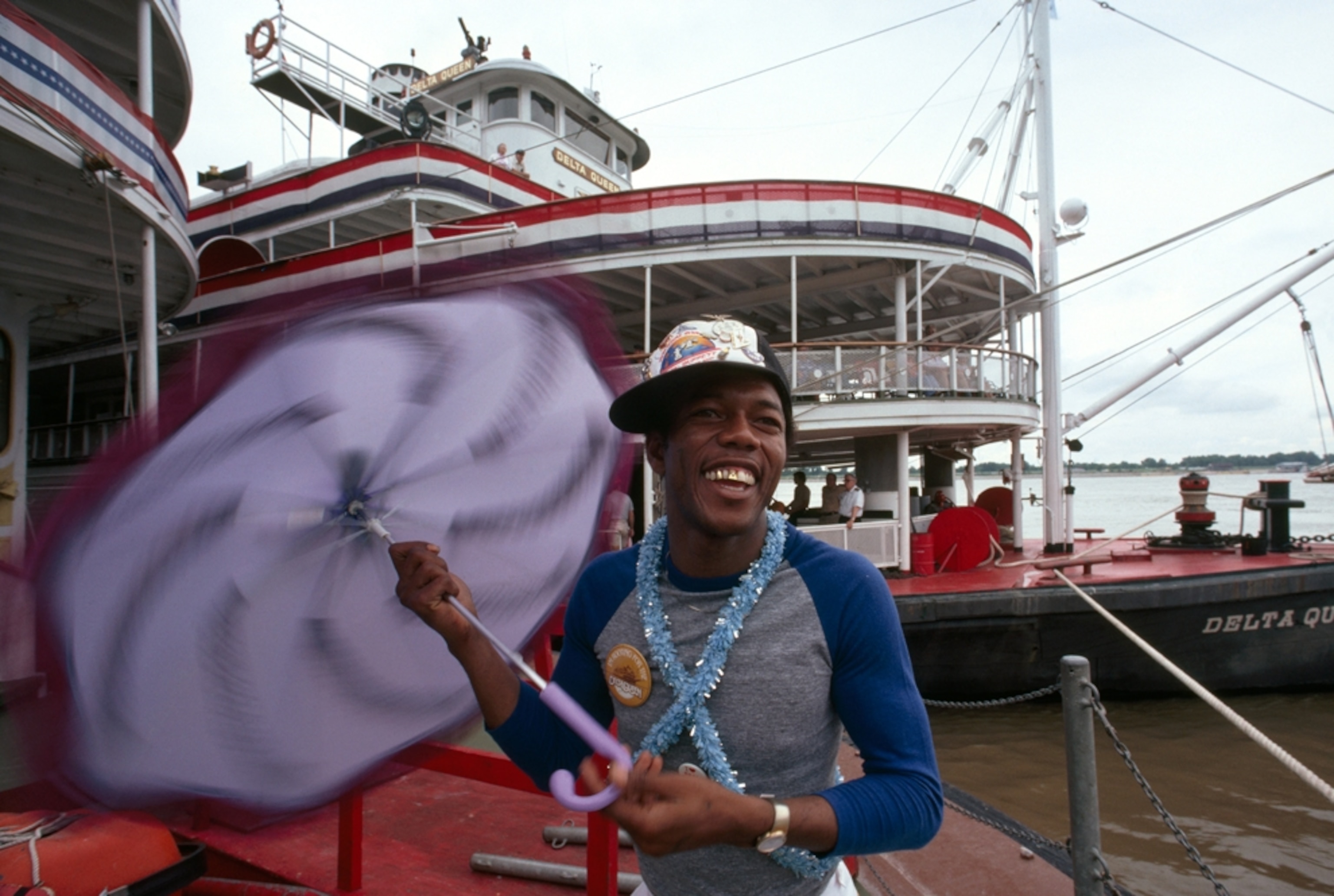 a young man in front of the Delta Queen riverboat on the Mississippi River