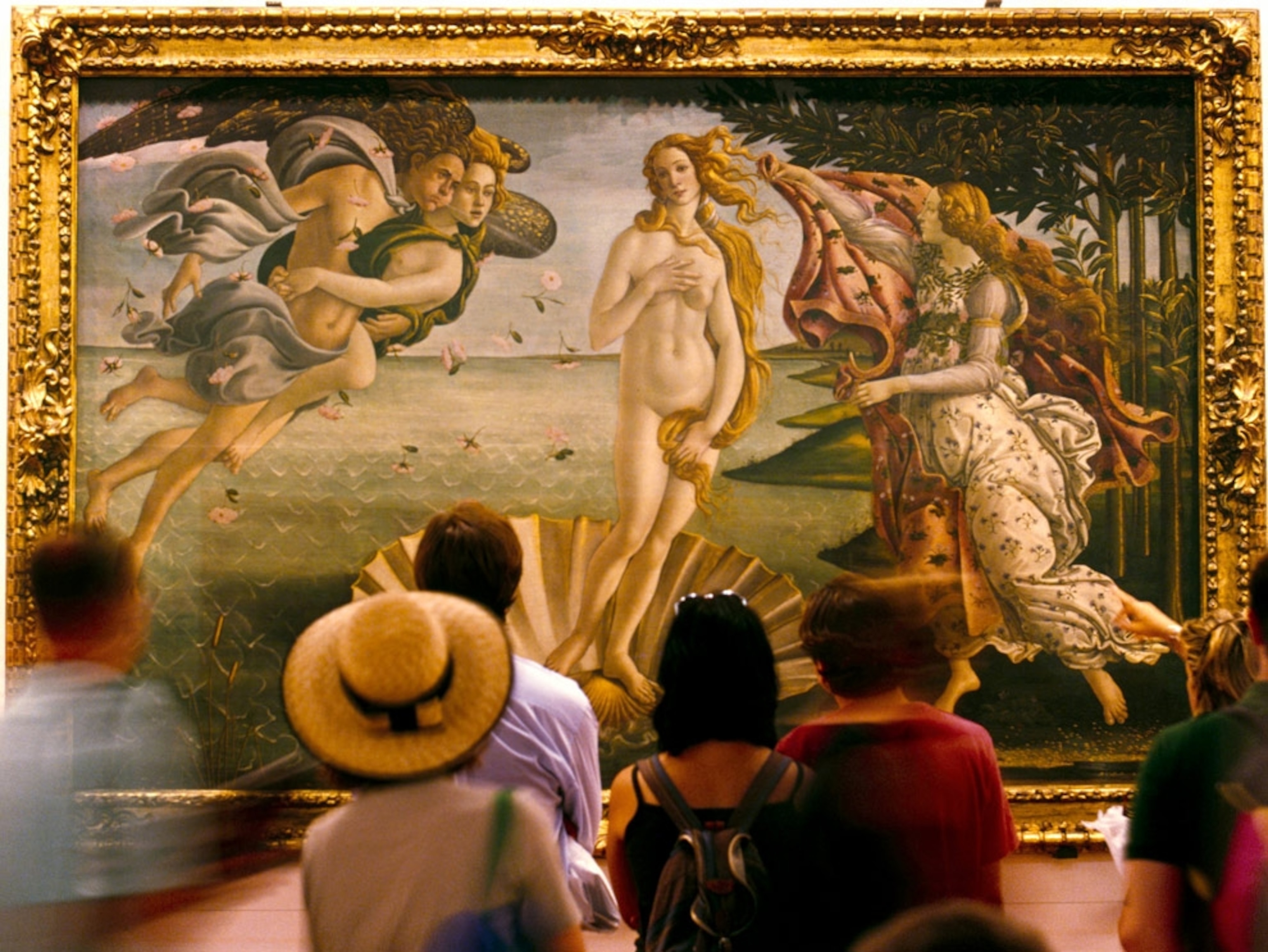 Visitors passing by a painting in an art gallery