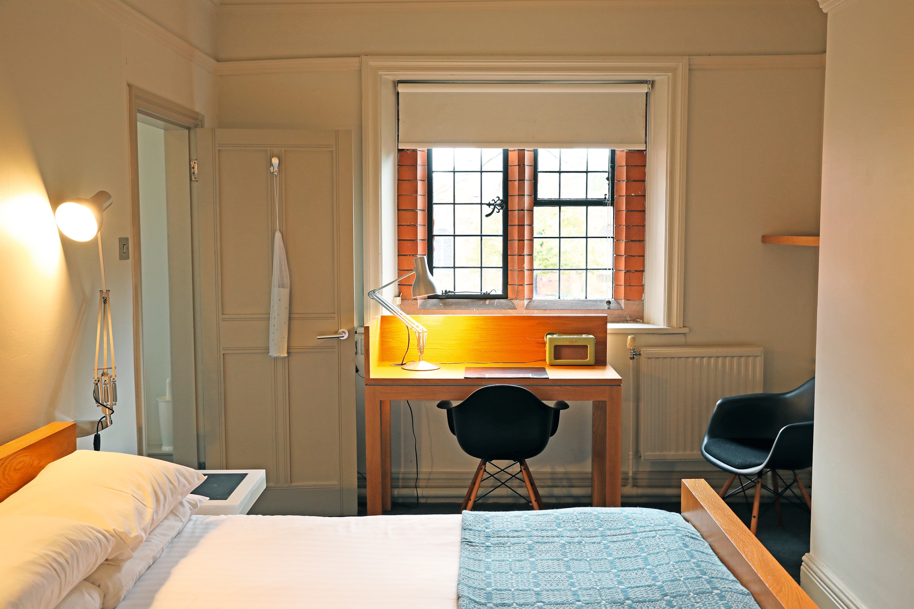 A small reading desk in a one of Gladstone Library's bedrooms, with a view overlooking the gardens, courtyards and local grounds.
