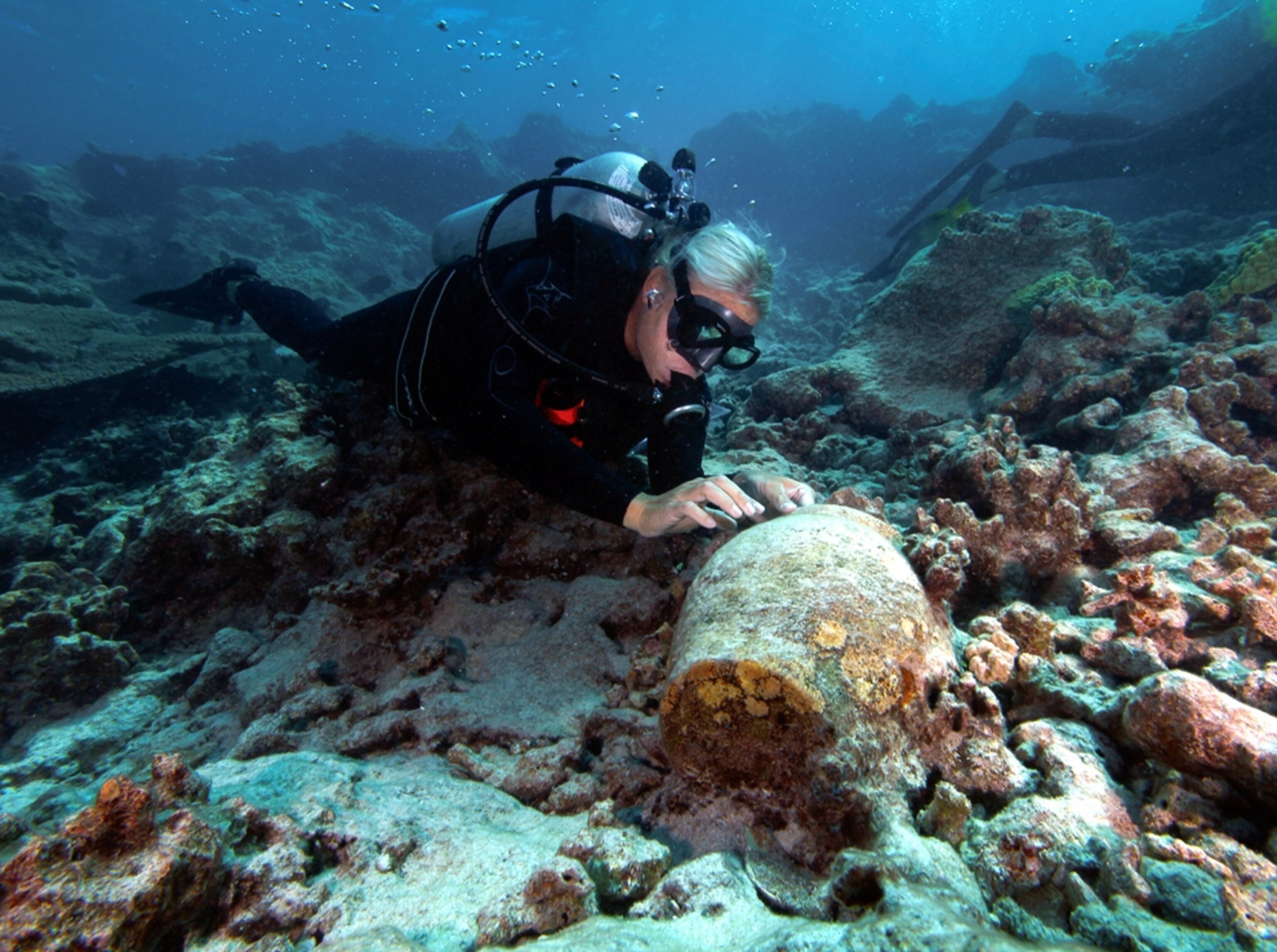 Picture: A maritime archaeologist looks at a ginger pot.