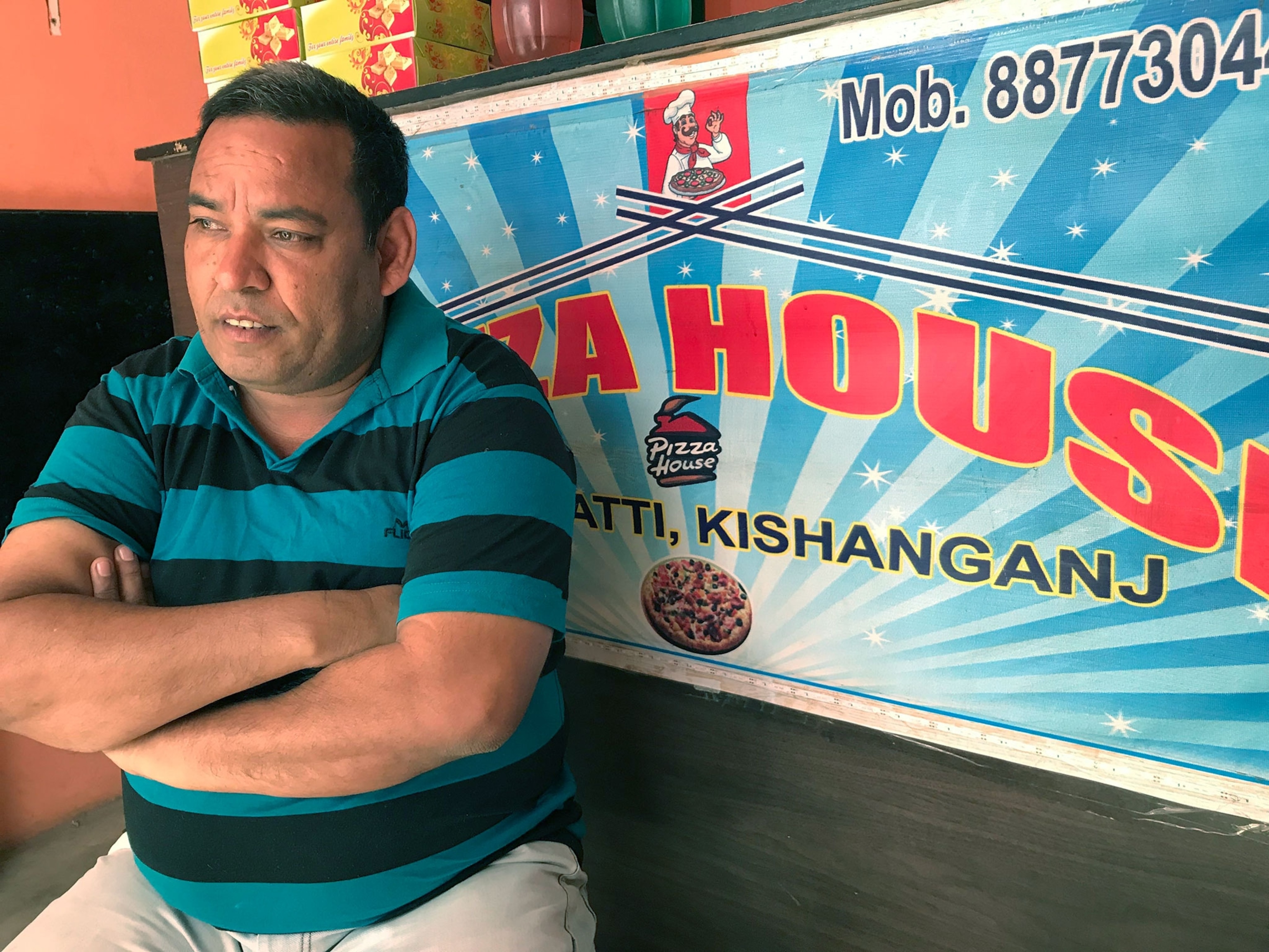 A photograph of a pizza maker in India