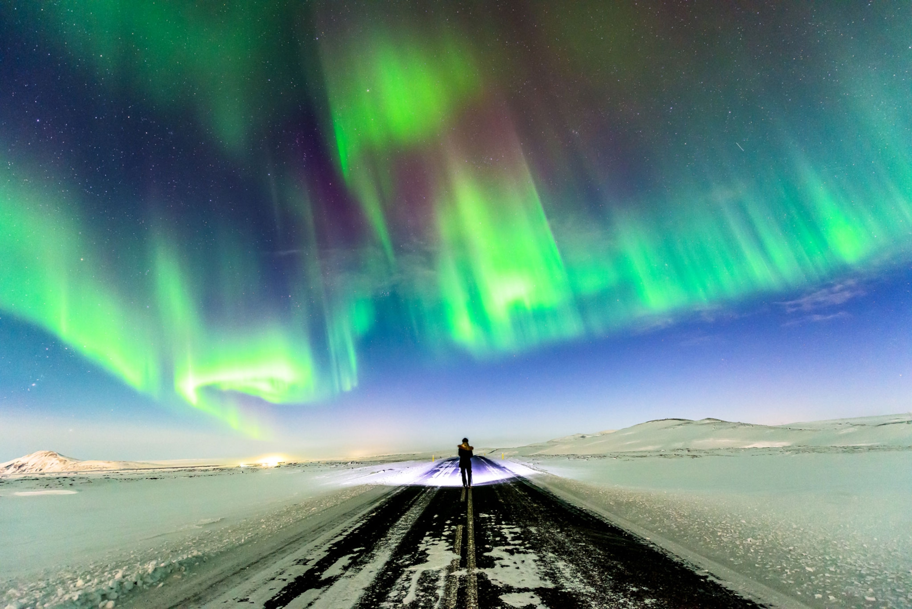 the Northern Lights dancing over the Iceland sky