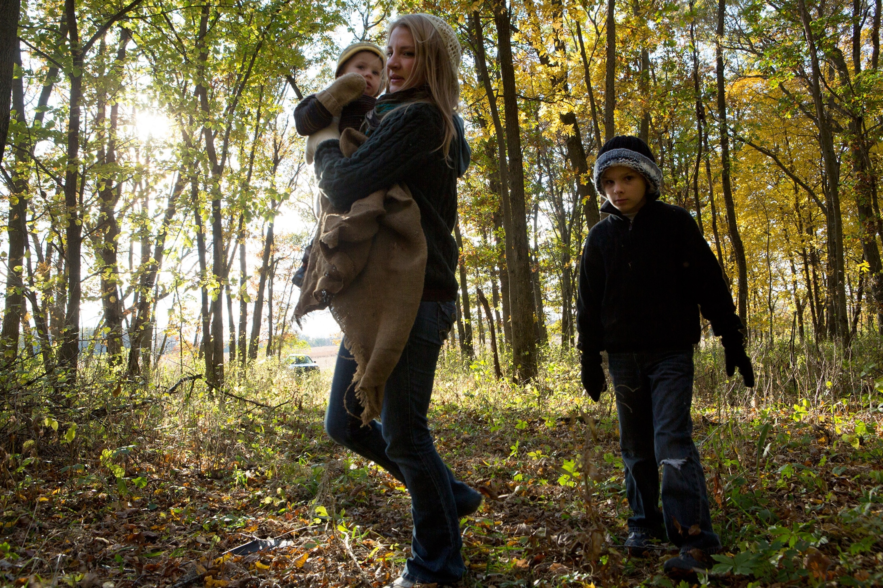 Kyera and her two sons foraging for food in the woods