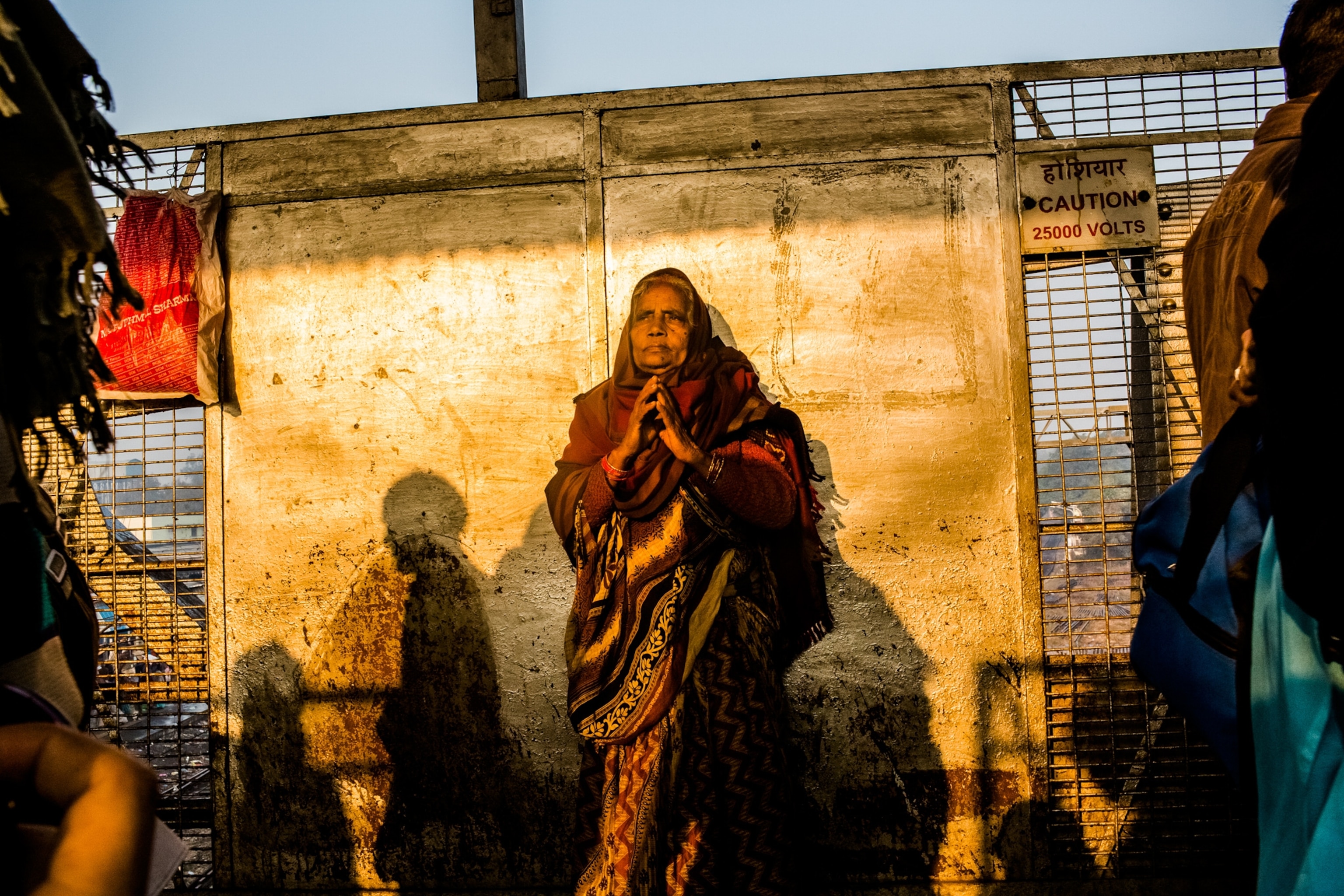 a woman praying at the Allahabad train station, India
