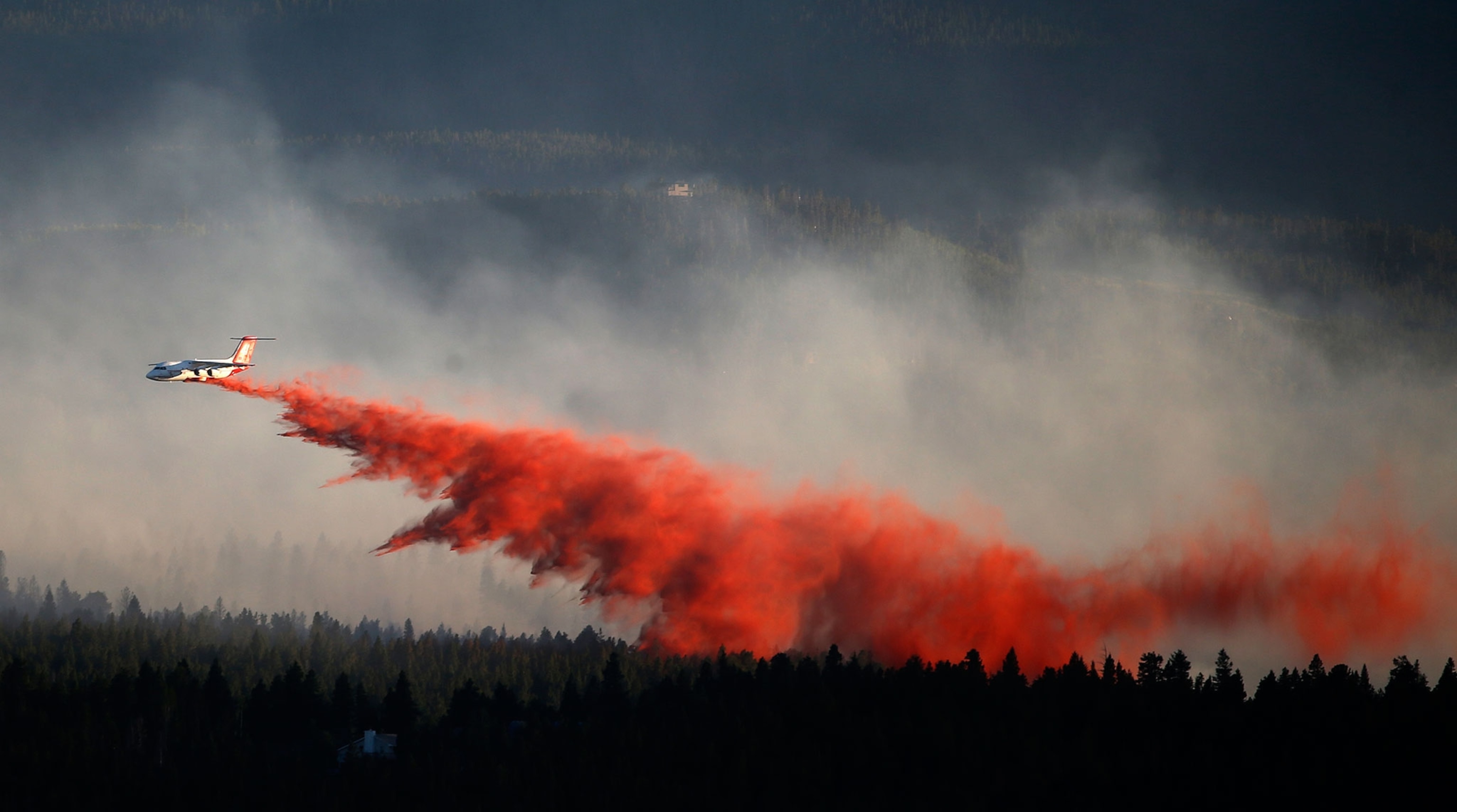 a slurry plane dropping slurry over the Cold Springs fire in Colorado