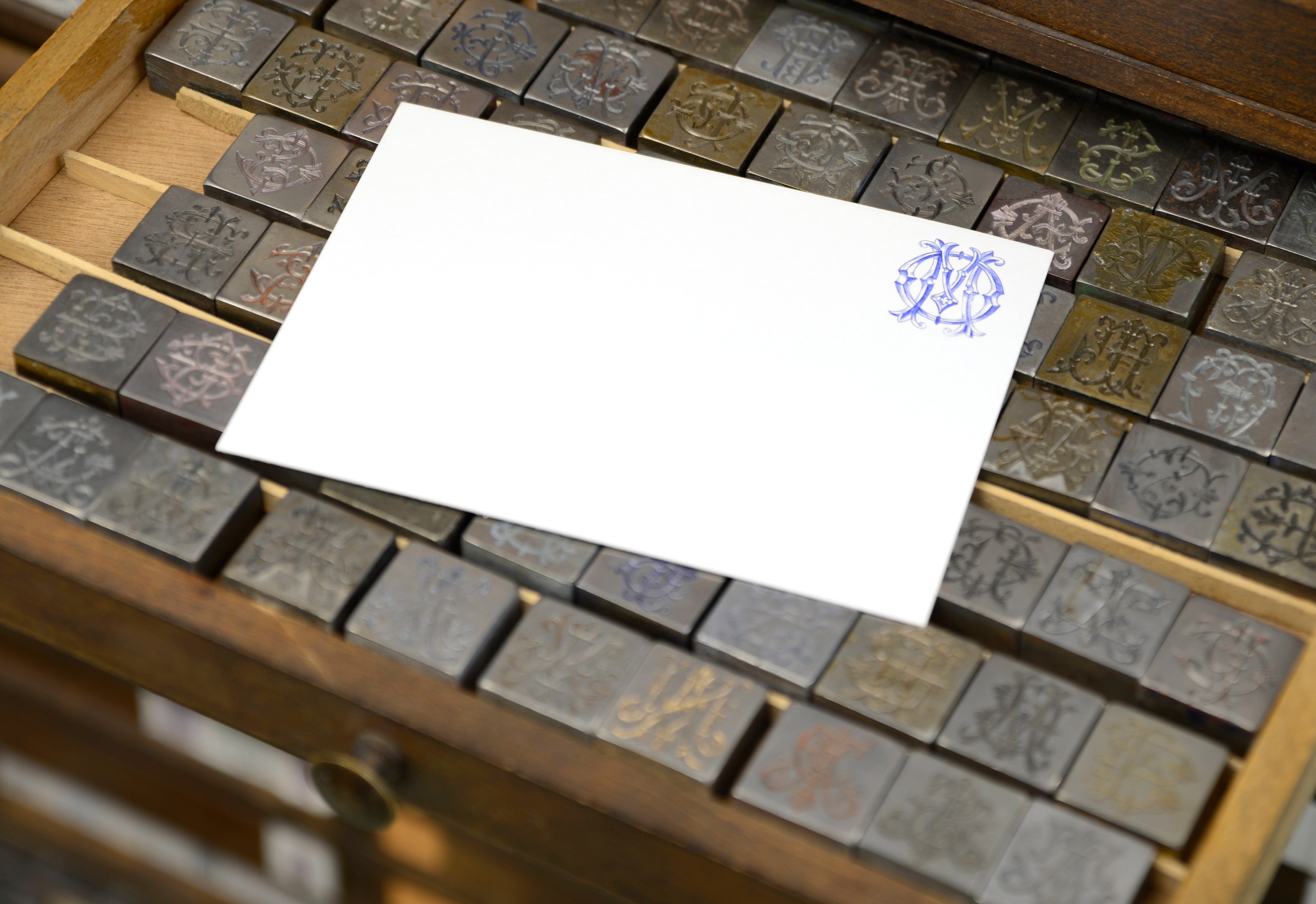 A stamped envelope sits on various metal stamps
