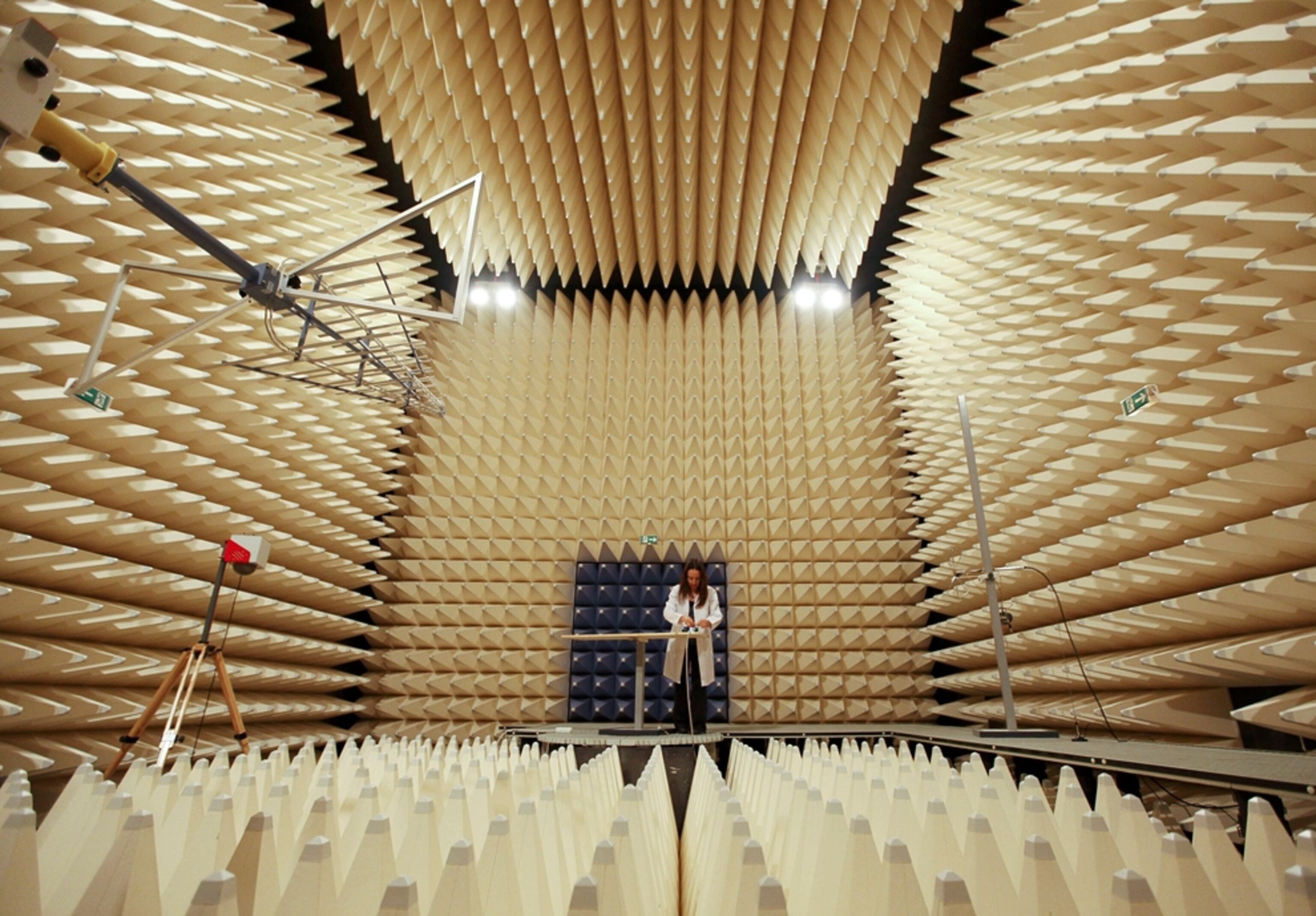 a technician examining a mobile phone in a testing facility in Turkey
