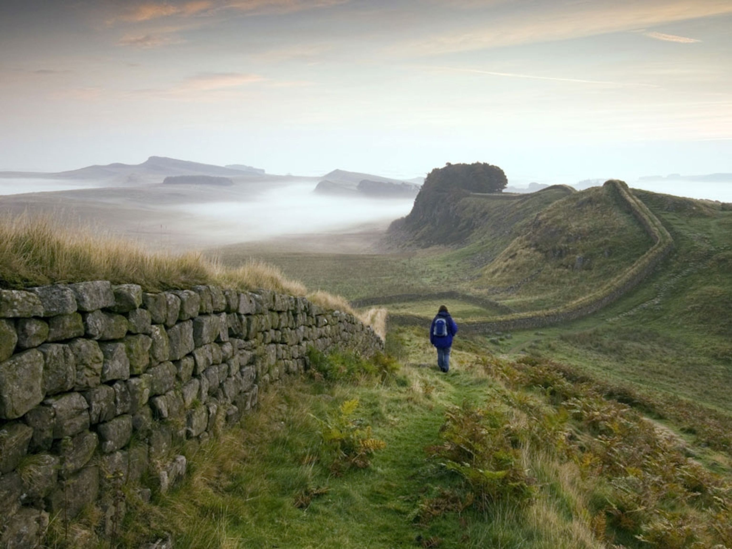 Hiker along ancient wall