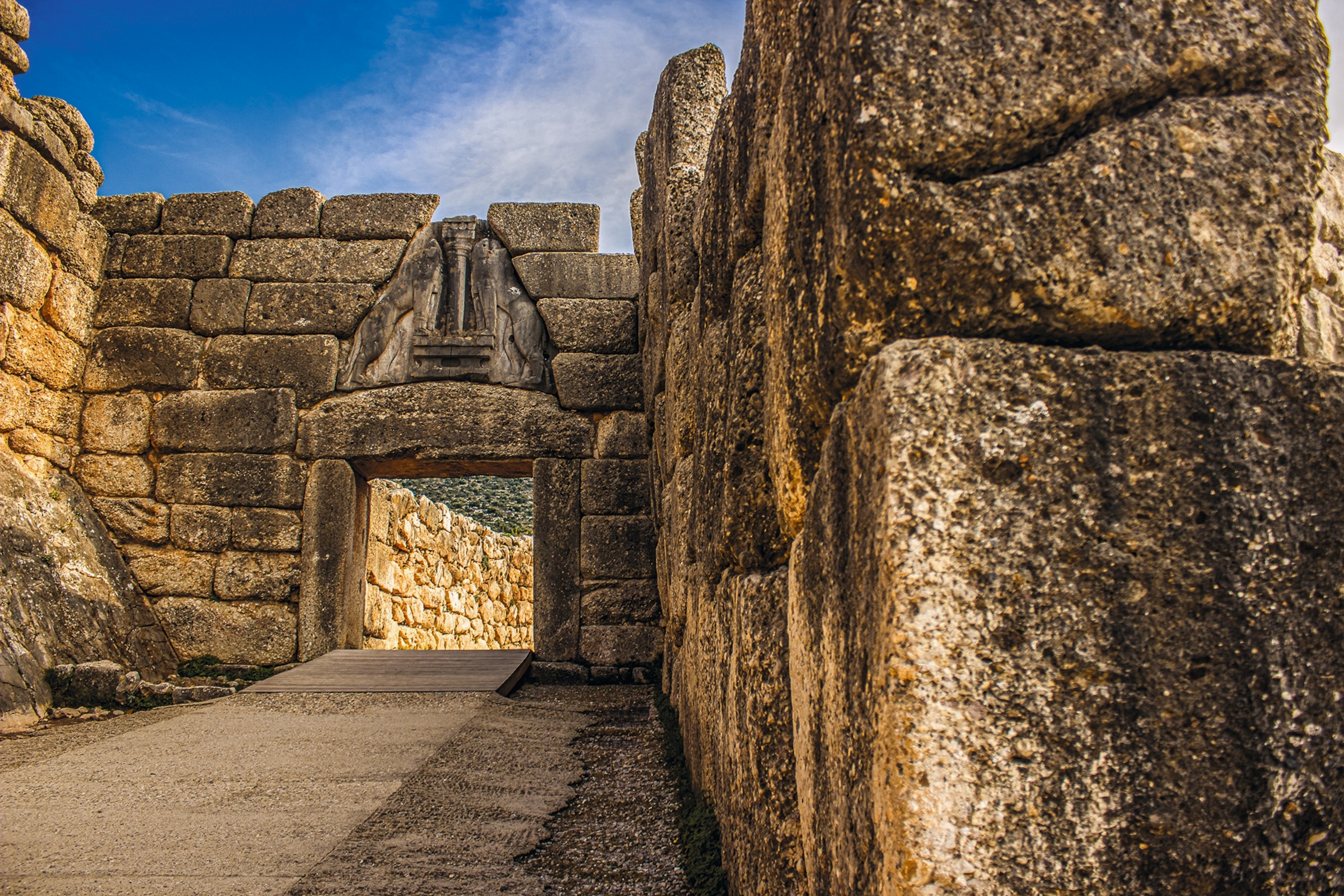The entrance to the mighty citadel of Mycenae is a monumental gateway, crowned with a relief of two rampant lion figures.