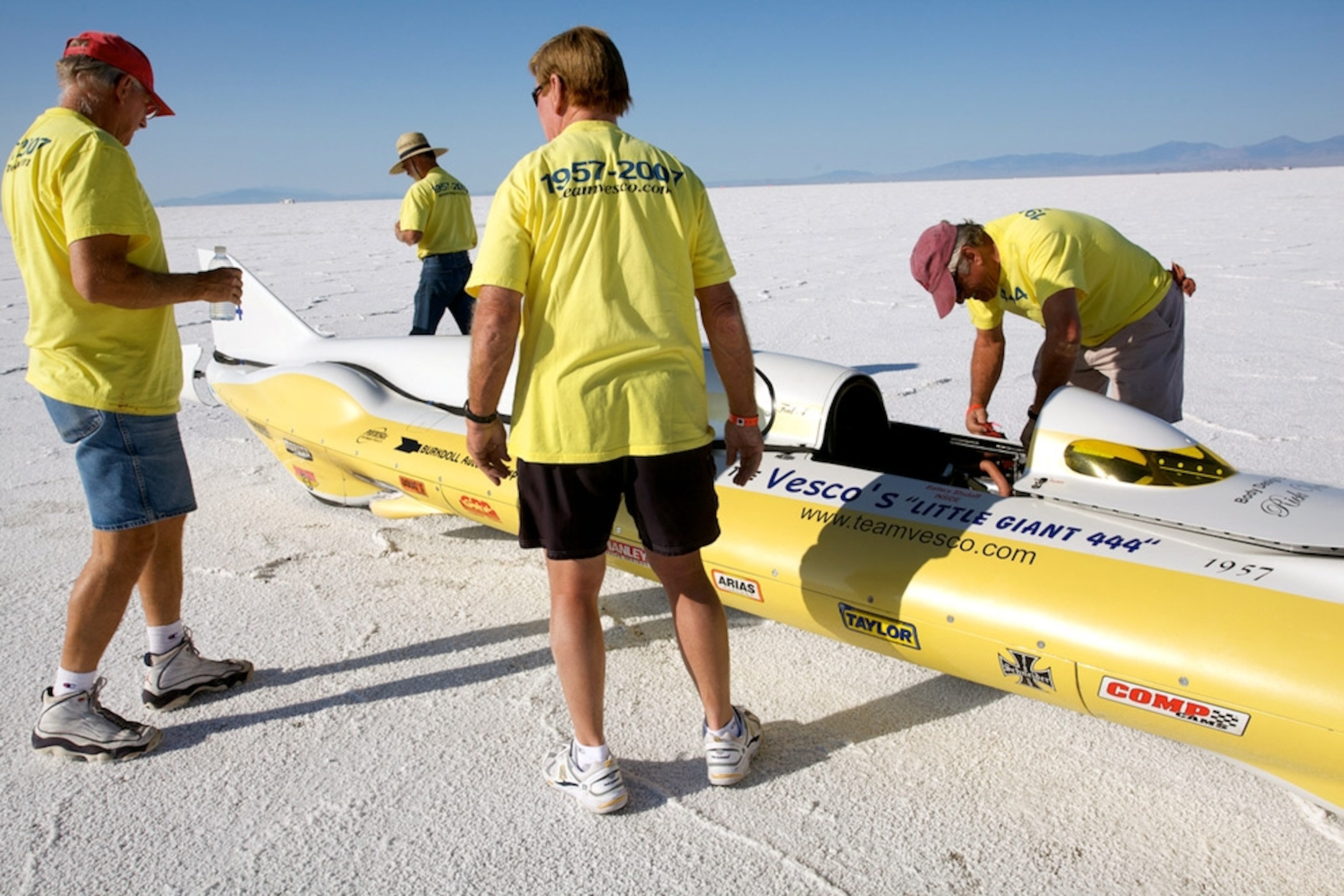 Racing crew working on car